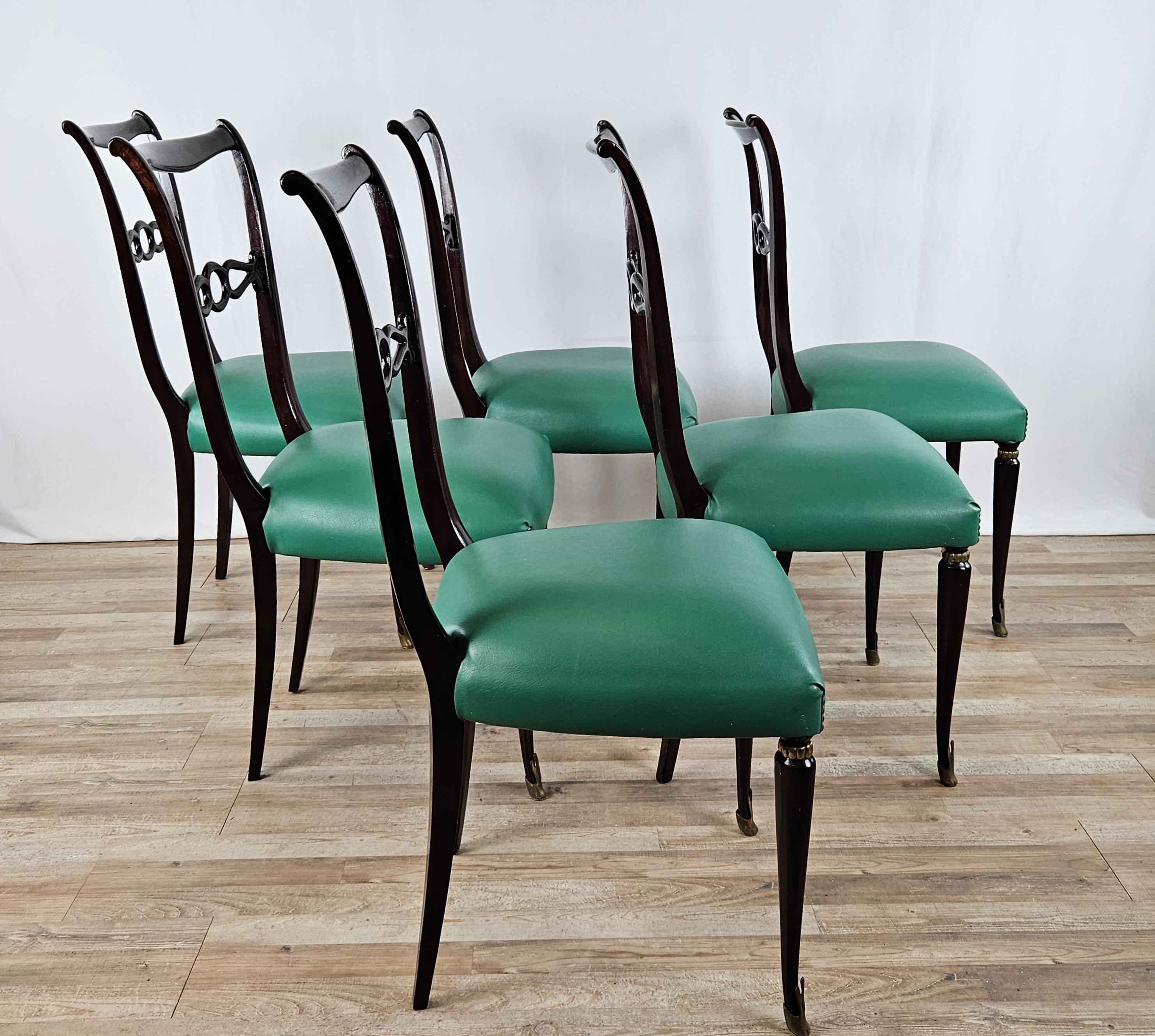 Elegant set of rosewood dining room chairs from the 1950s designed based on Paolo Buffa's design, high quality Italian production.

The chairs feature machining in the center back and large, comfortable upholstered seats covered in