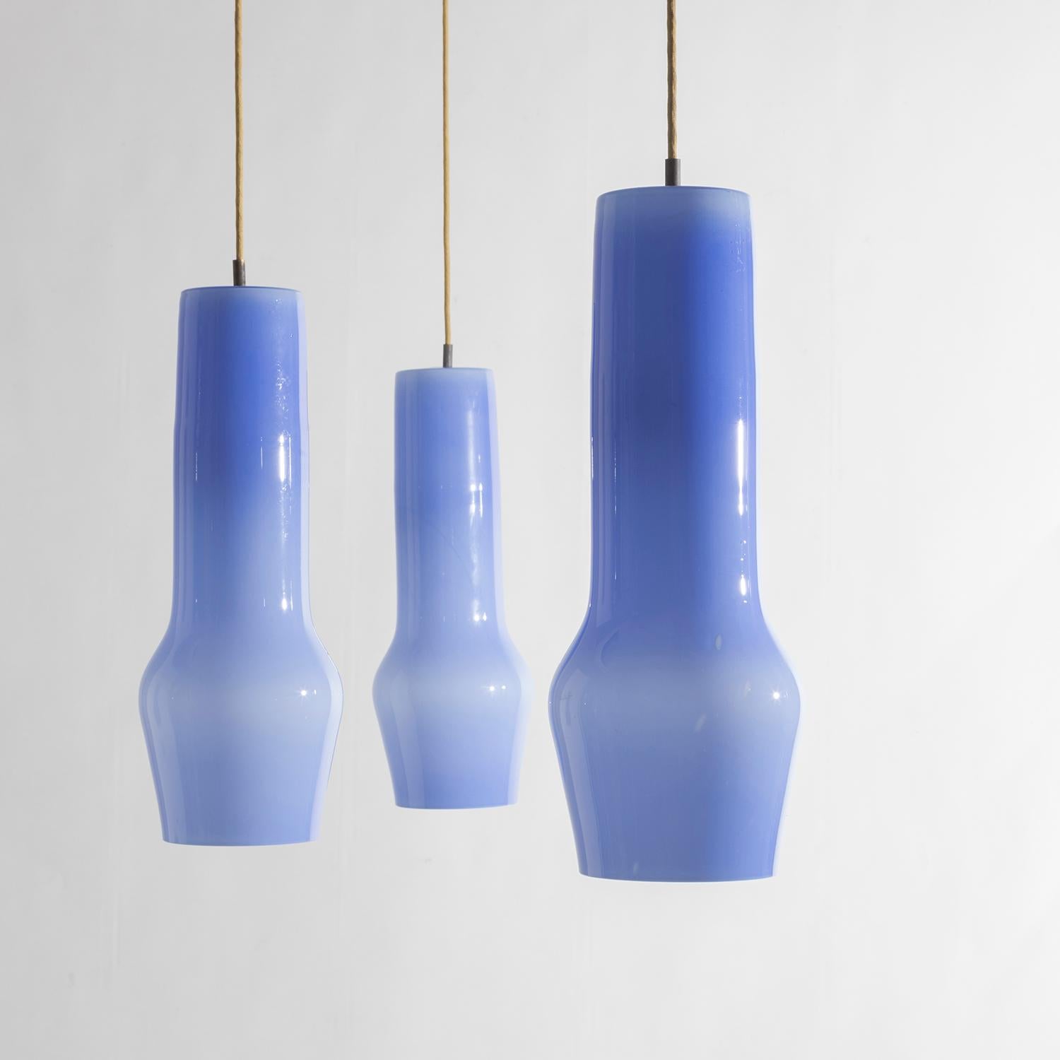 Set of Three pendants mod. 4041 in light blue etched Murano Glass designed by Massimo Vignelli and produced by Venini since 1954. Perfect condition, original electrical system and original brass ceiling cups.