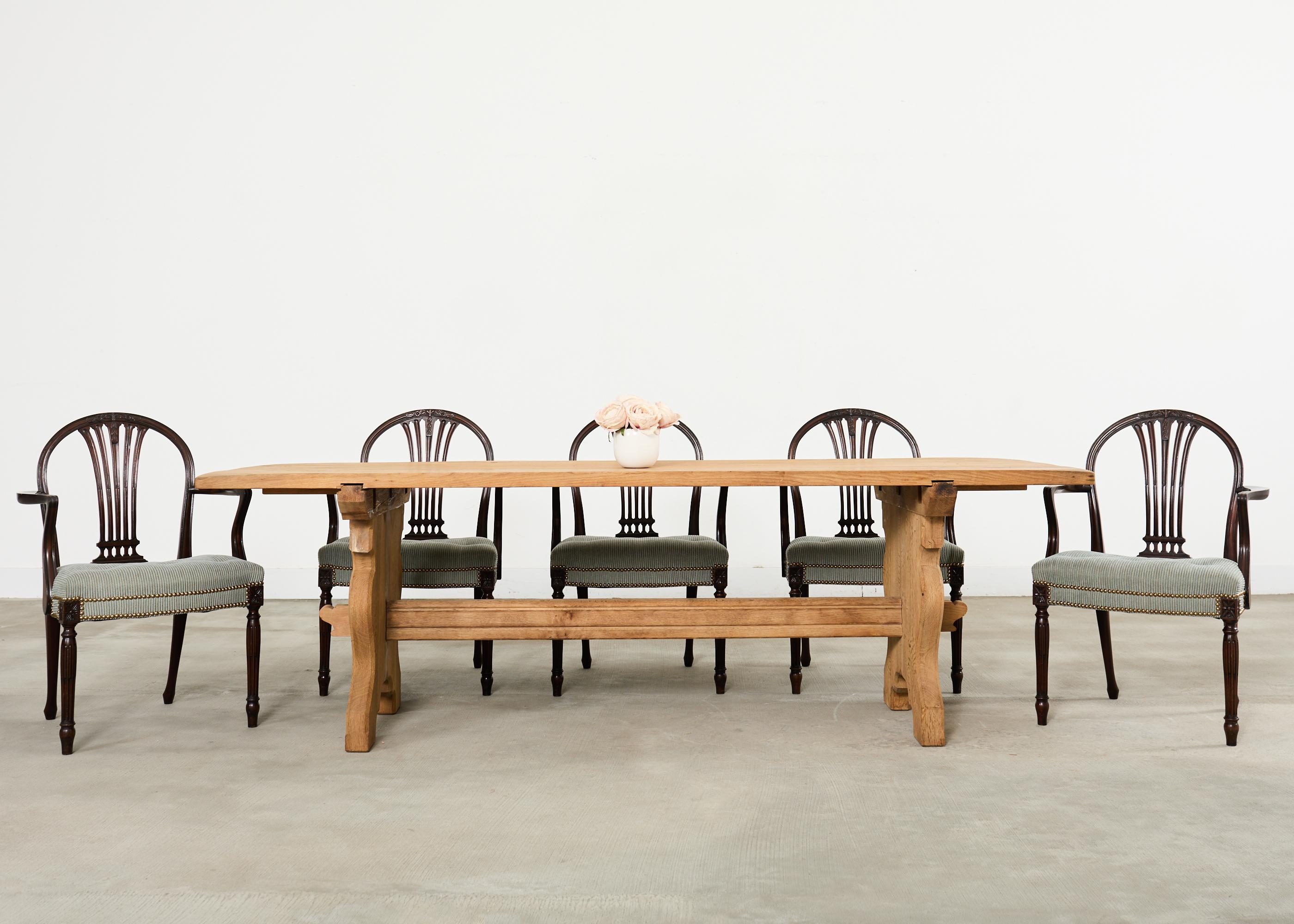 Elegante set di otto poltrone da pranzo in mogano francese realizzate secondo il grande gusto Luigi XVI. Il set è composto da tutte le poltrone con braccioli alti 27 pollici. Le cornici in mogano scuro sono caratterizzate da un grazioso arco di