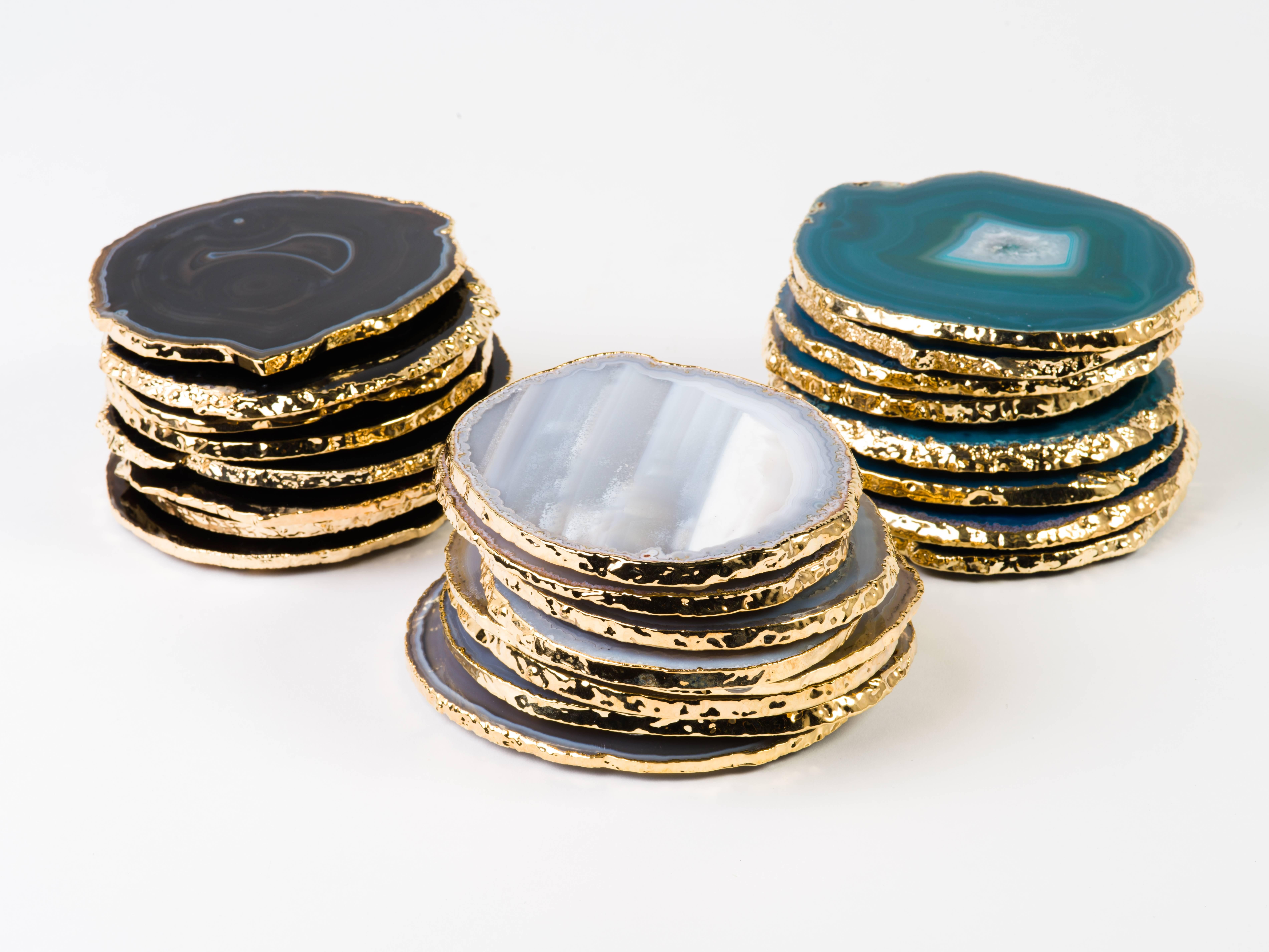 Stunning natural agate and crystal coasters with 24-karat gold-plated edges. Polished fronts and natural rough edges. No pieces are alike. Make beautiful accessories to any coffee table or dining table setting. Three color variations are available: