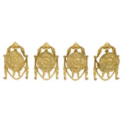 Set di quattro appendiabiti in bronzo e ottone