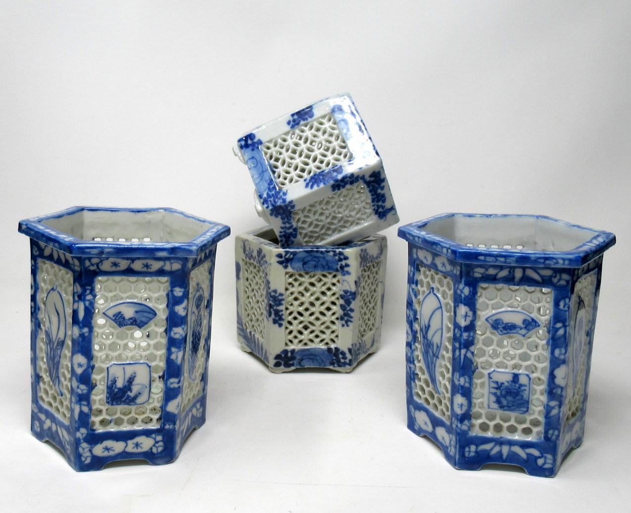 Stylish set of four hand painted Japanese or Chinese export reticulated pierced blue and white porcelain vases of hexagonal outline. circa first half of the 20th century. 

Each finely hand decorated on all outer panels depicting flowers and