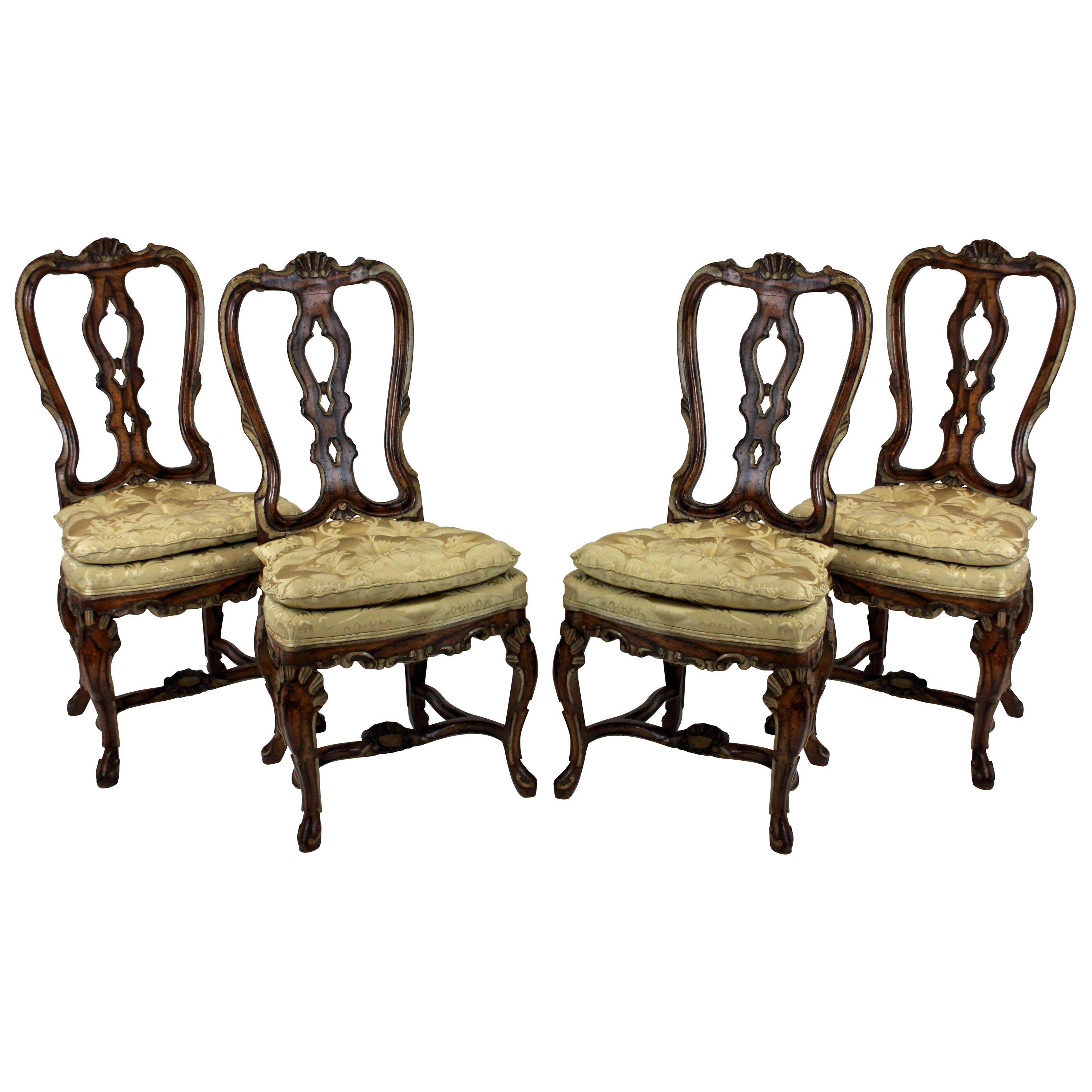 A set of four fine high back George II dining chairs in faux walnut with painted detail. Beautifully carved with silk damask seats.
 