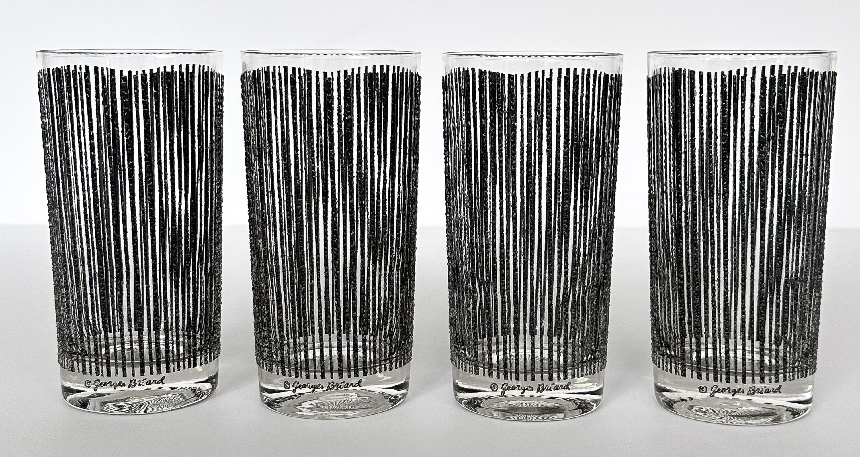 Discover the epitome of cocktail sophistication with this set of four mid-century modern Georges Briard “icicle” pattern highball glasses in black. The 