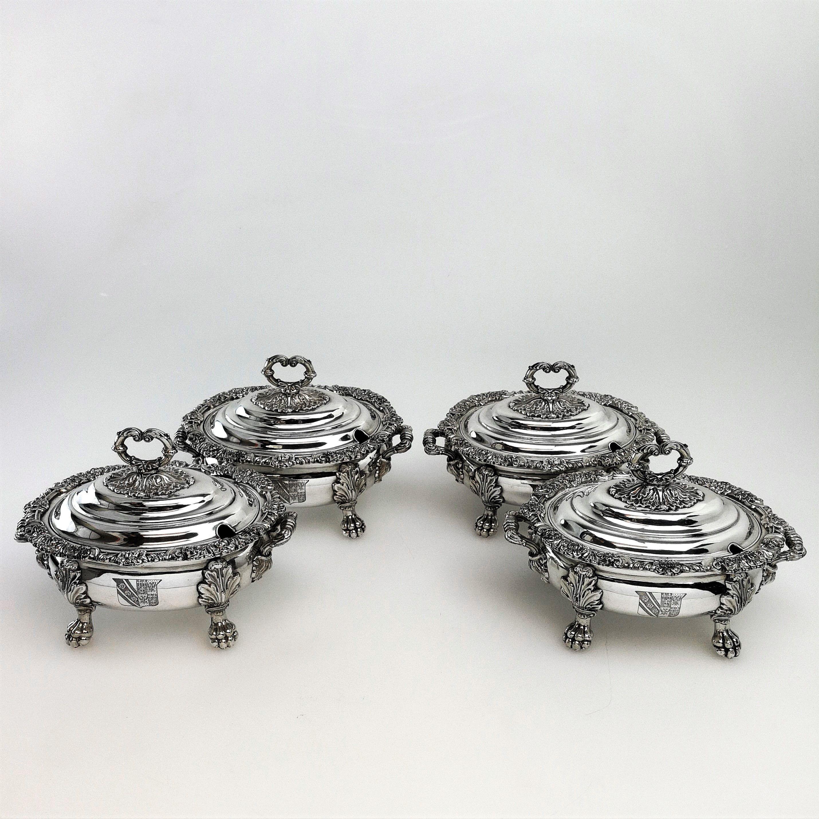 A set of four antique George IV Georgian Old Sheffield Plate Sauce Tureens. These oval Tureens each Stand on four impressive claw feet and have domed fitted lids with scroll finials. The Rims of the Tureens are embellished with a floral and scroll