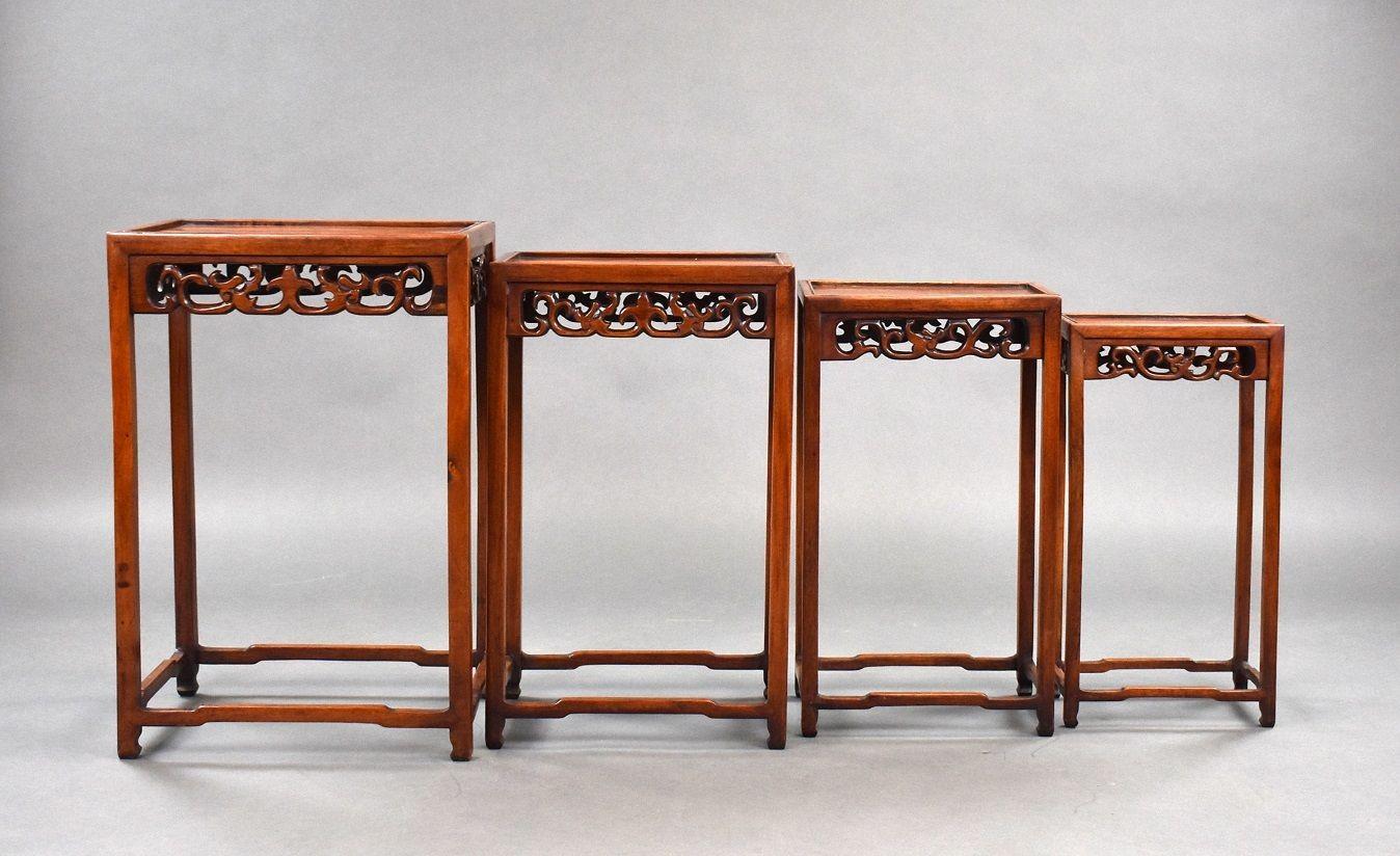 Set Four graduated Chinese hardwood nest tables in good condition with intricate carvings to the front and sides circa 1890