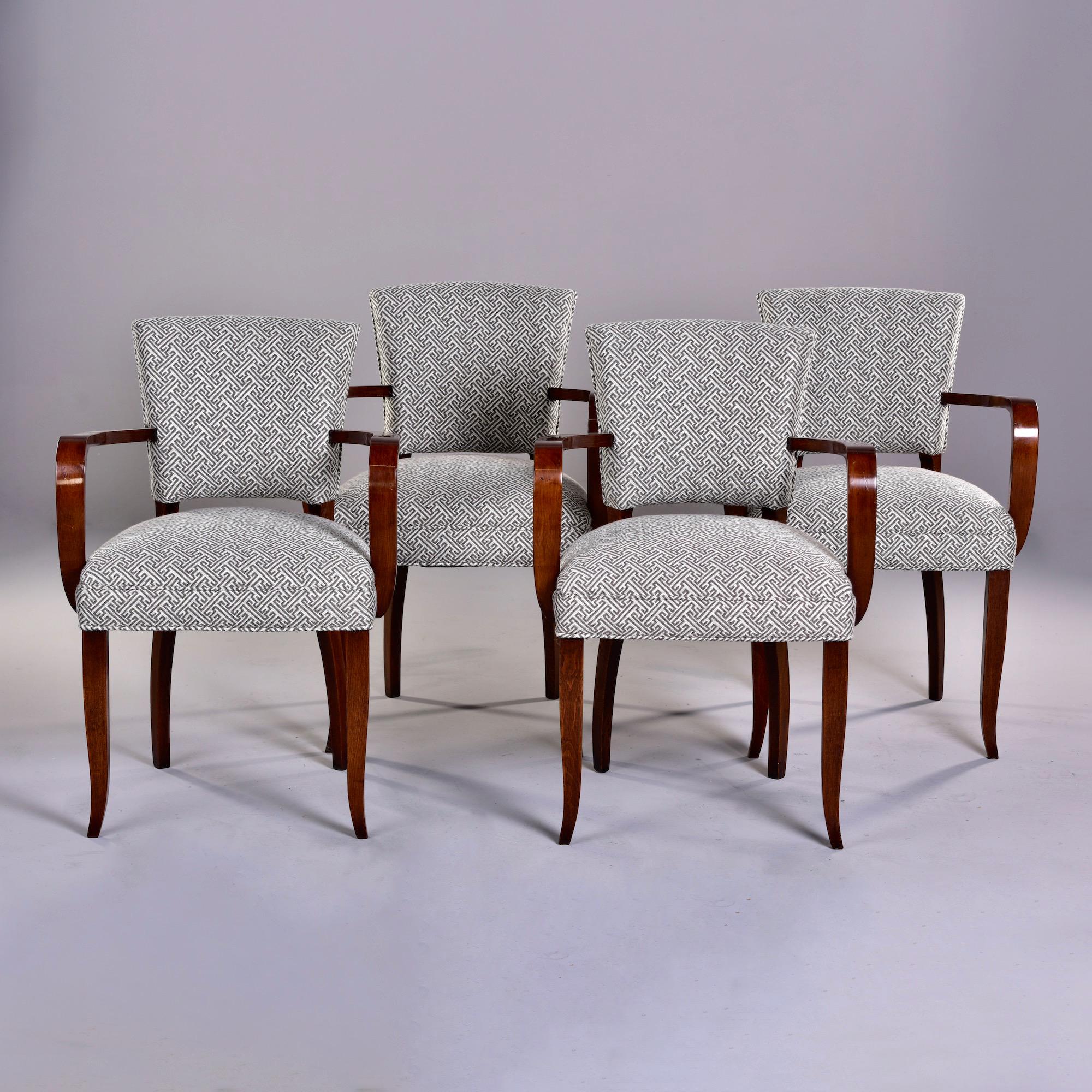 Found in England, this set of circa 1940s bridge chairs have mahogany frames with dramatic curved arms and subtly tapered saber legs. Newly upholstered in a woven gray and cream geometric lattice like pattern. Frames were professionally darkened and