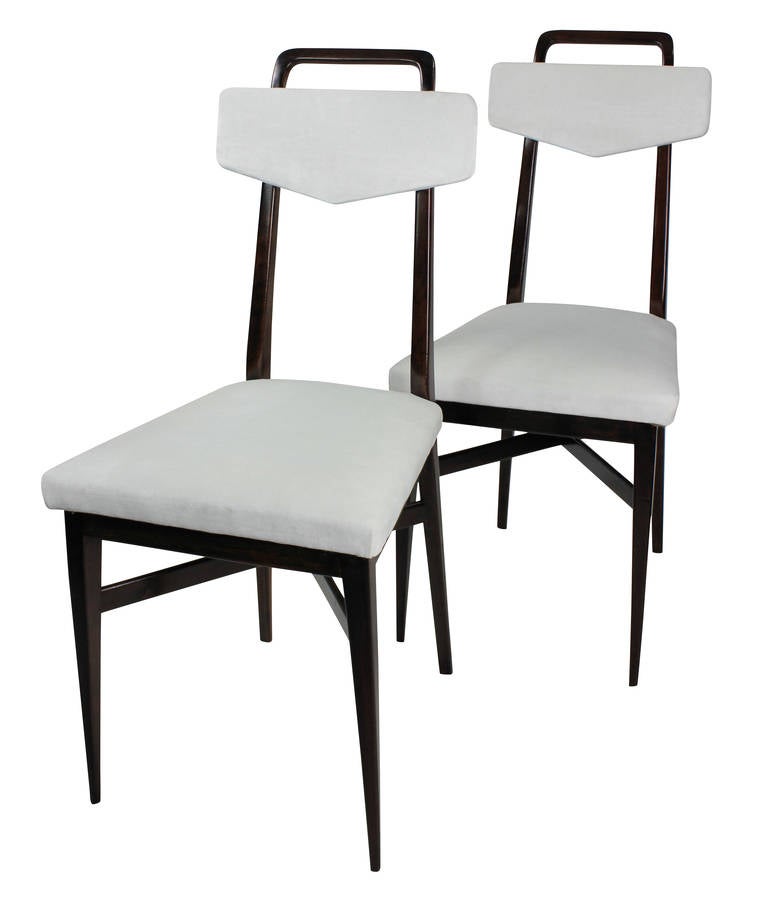 A set of four Italian kitchen chairs in the manner of Parisi in solid mahogany with over stuffed seats and backs in white velvet. With brass detail.

  