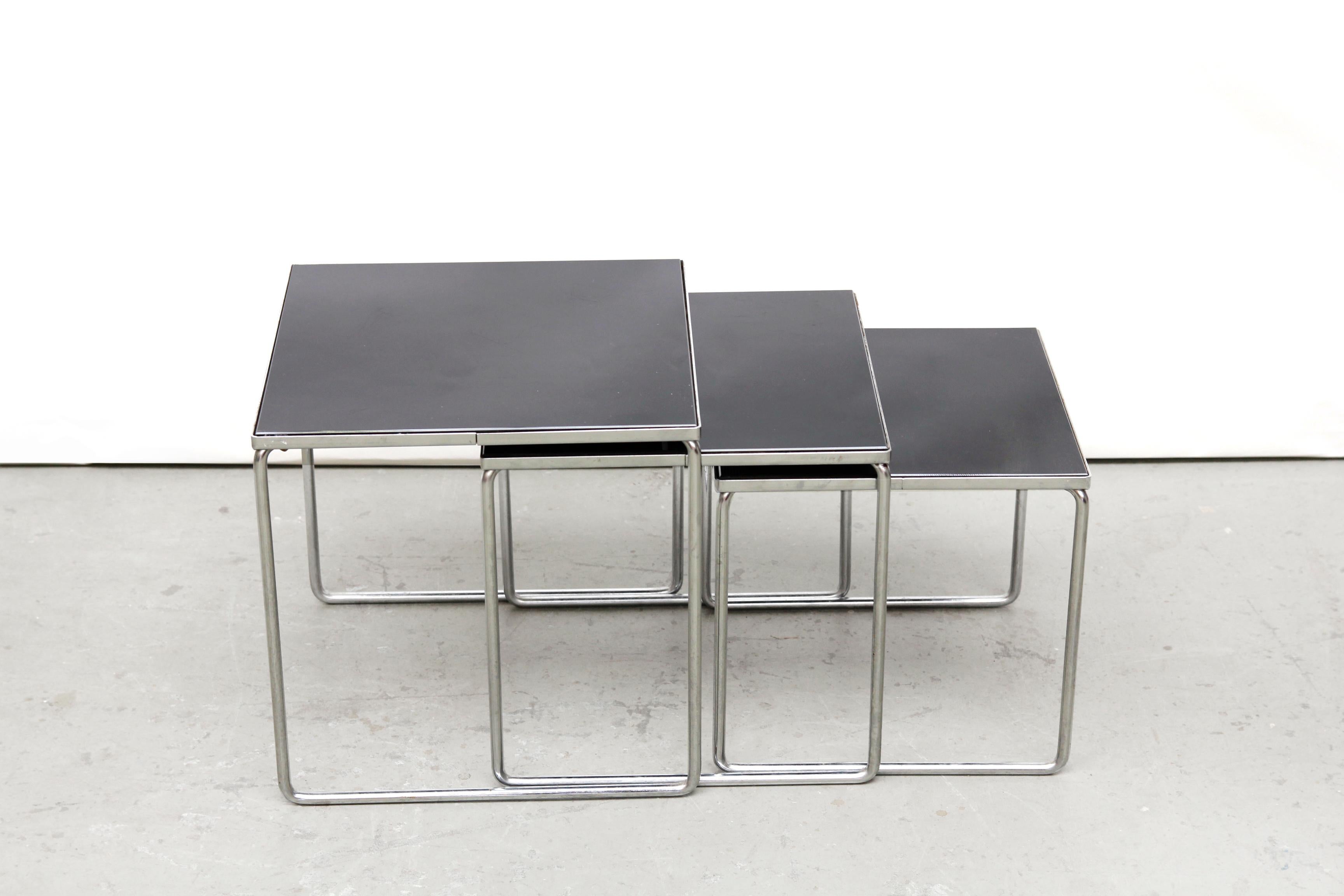 Vintage chrome with black glass side tables. Useful as separate side tables, which can be conveniently placed under each other if they are not allowed to take up too much space. But that can also be used in various places in the house. These tables
