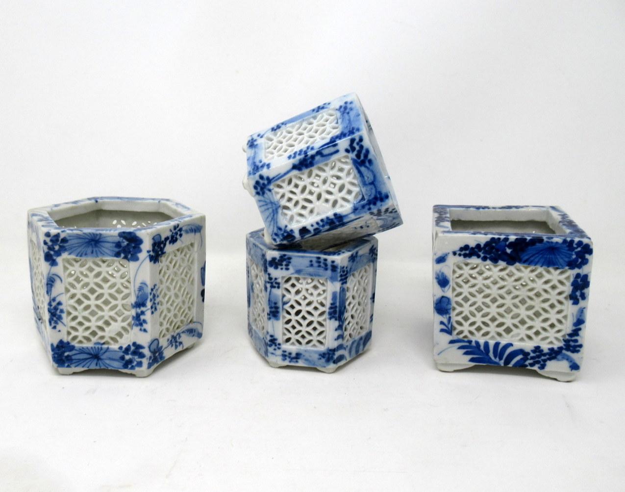 Stylish assembled set of four hand painted Chinese Export reticulated pierced blue and white porcelain vases of hexagonal and square outline, circa first half of the 20th century.

Each finely hand decorated on all outer panels depicting flowers