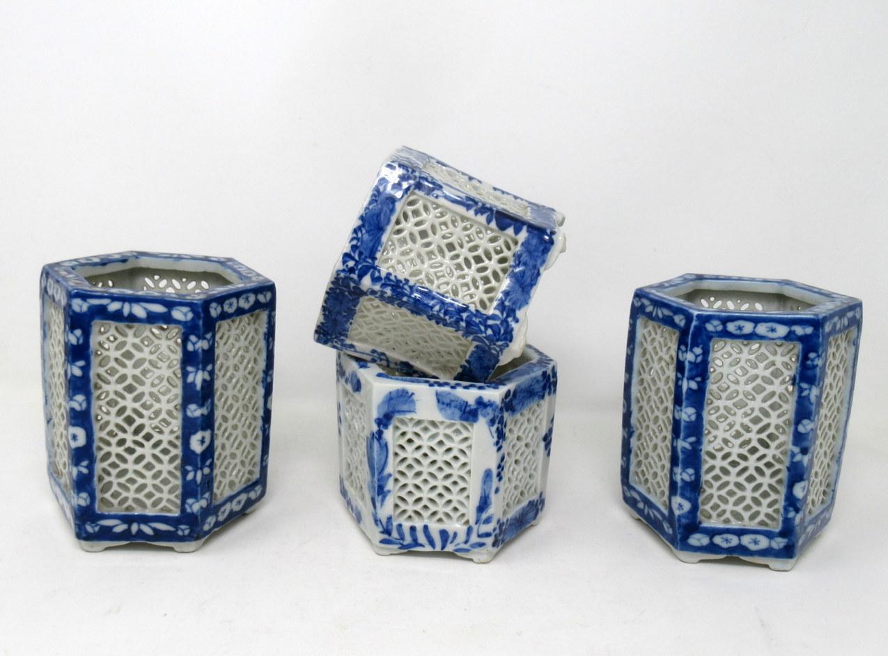 Stylish assembled set of four hand painted Chinese Export reticulated pierced blue and white porcelain vases all of hexagonal outline, circa first half of the 20th century.

Each finely hand decorated on all outer solid panels depicting flowers and