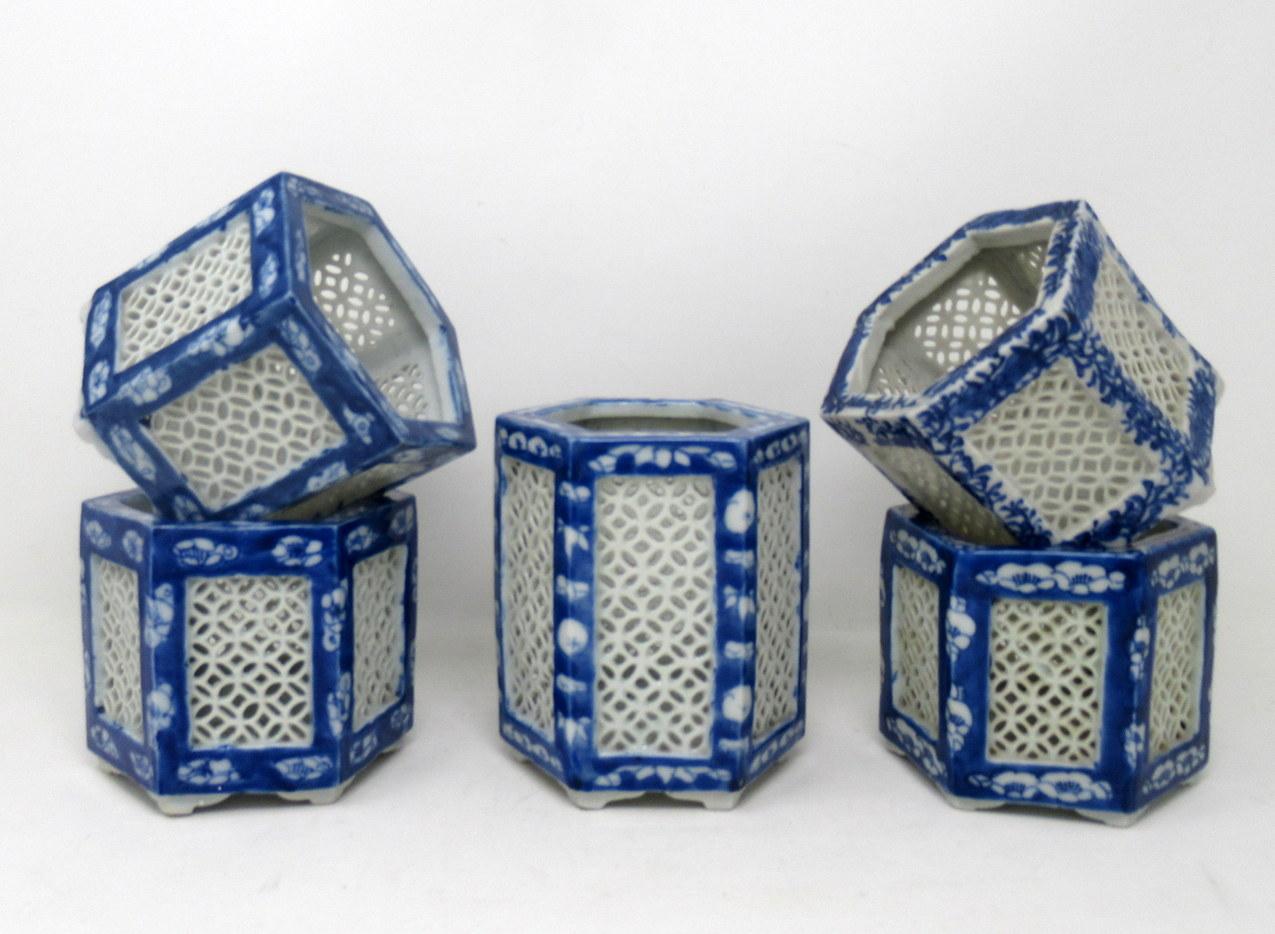 Stylish assembled set of five hand painted Chinese Export reticulated pierced blue and white porcelain vases of hexagonal outline, circa first half of the 20th century.

Each finely hand decorated on all outer panels depicting flowers and
