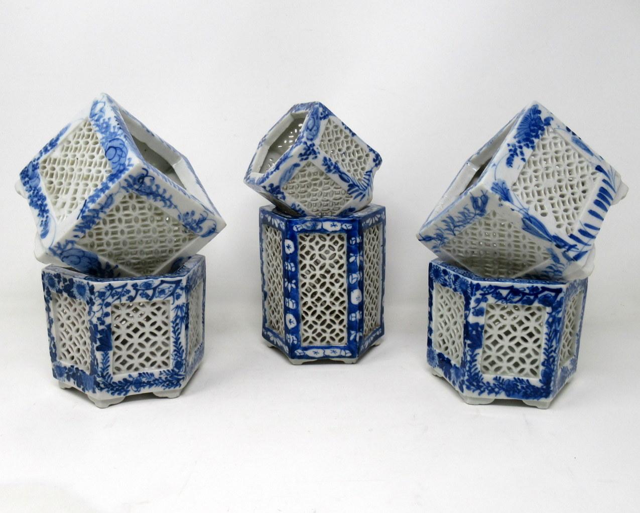 Stylish assembled set of six hand painted Chinese Export reticulated pierced blue and white porcelain vases of hexagonal and square outline, circa first half of the 20th century. 

Each finely hand decorated on all outer panels depicting flowers