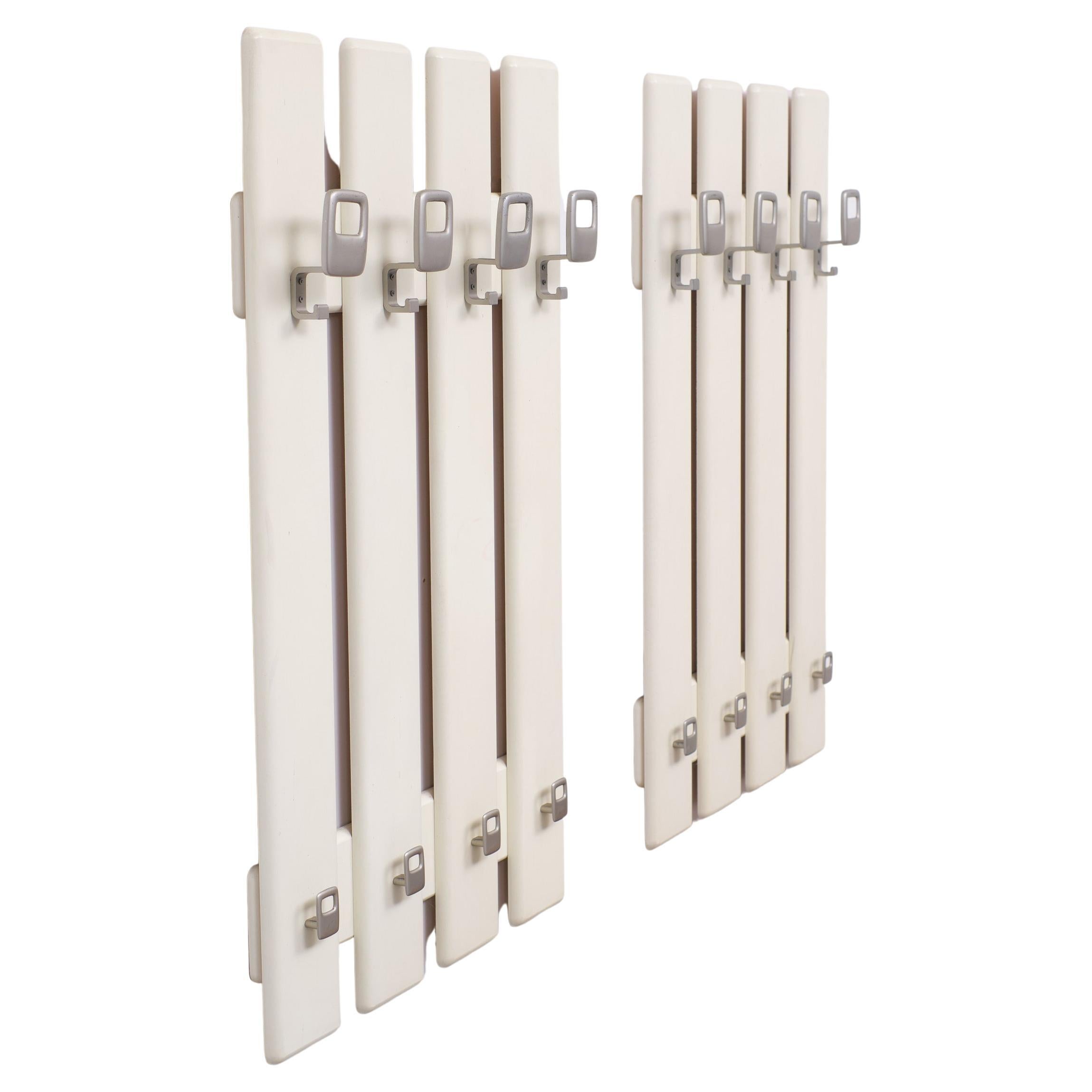 Typical for the 1970s, this set of identical hanging Coat Racks, Creme color.
wooden frame, comes with aluminum color Metal hooks. 
Good condition overall.
 Please don't hesitate to reach out for alternative shipping quotes