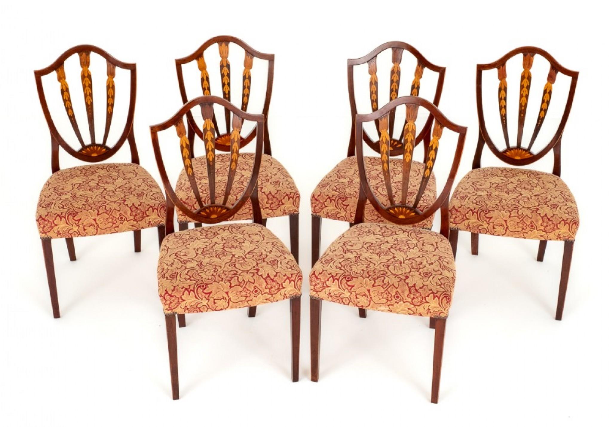 Set of 6 Mahogany Hepplewhite Style inlaid Dining Chairs.
These Rather Pretty Chairs Stand upon Tapered Legs.
The Seats Being of a Stuff Over Form (very comfortable)
the Backs of The Chairs are of a Shield Form and Feature Marquetry Inlays.
Circa
