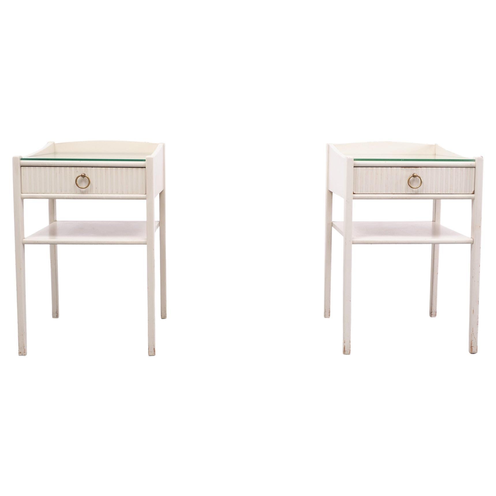 Love this set of early Ikea  nightstands . Beautiful shape and off White color,
one drawer. Brass ring handles and glass plates on top.
Nice elegant set . 
Please don't hesitate to reach out for alternative shipping quotes