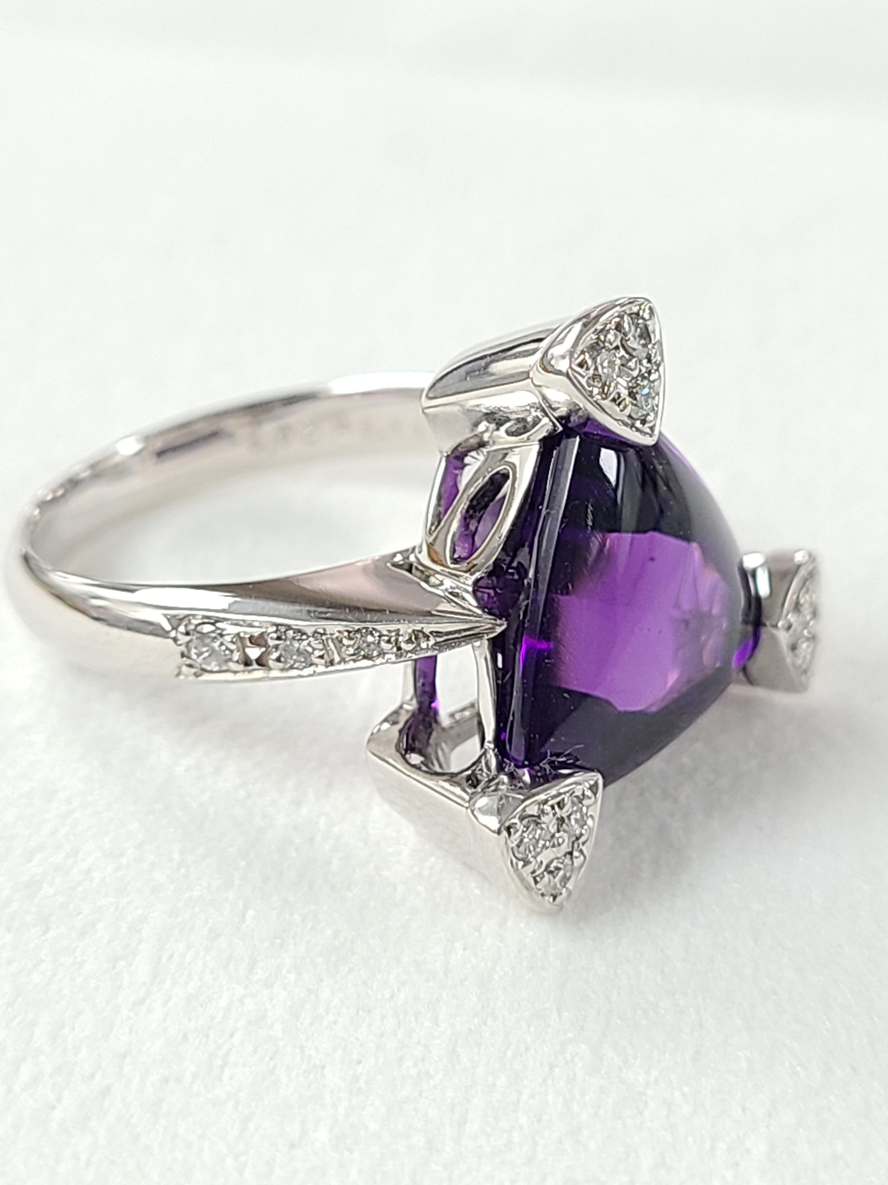 A gorgeous and Chic Amethyst ring set in 18k white gold . The amethyst is a special Trillion cut Cabochon with a beautiful colour and is Eye clean . The weight of the Amethyst is 5.92 carats and diamond weight is .54 carats . Ring dimensions in cm