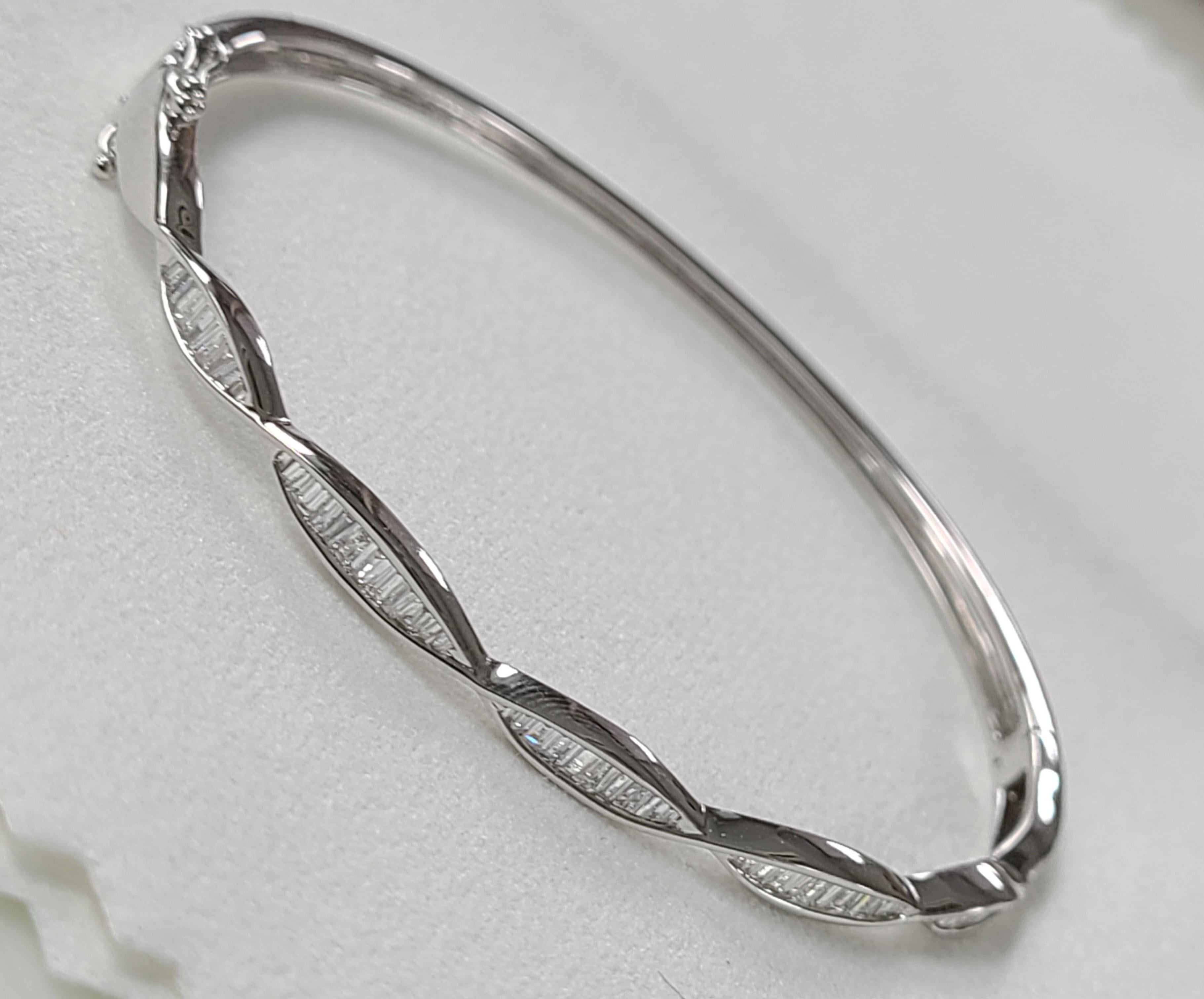 A simple and Elegant openable bracelet/bangle in 18k white gold with baguette diamonds . the diamond weight is .38 carats . Dimensions in cm .3 x 6 x 5 (broad x width x diameter) .