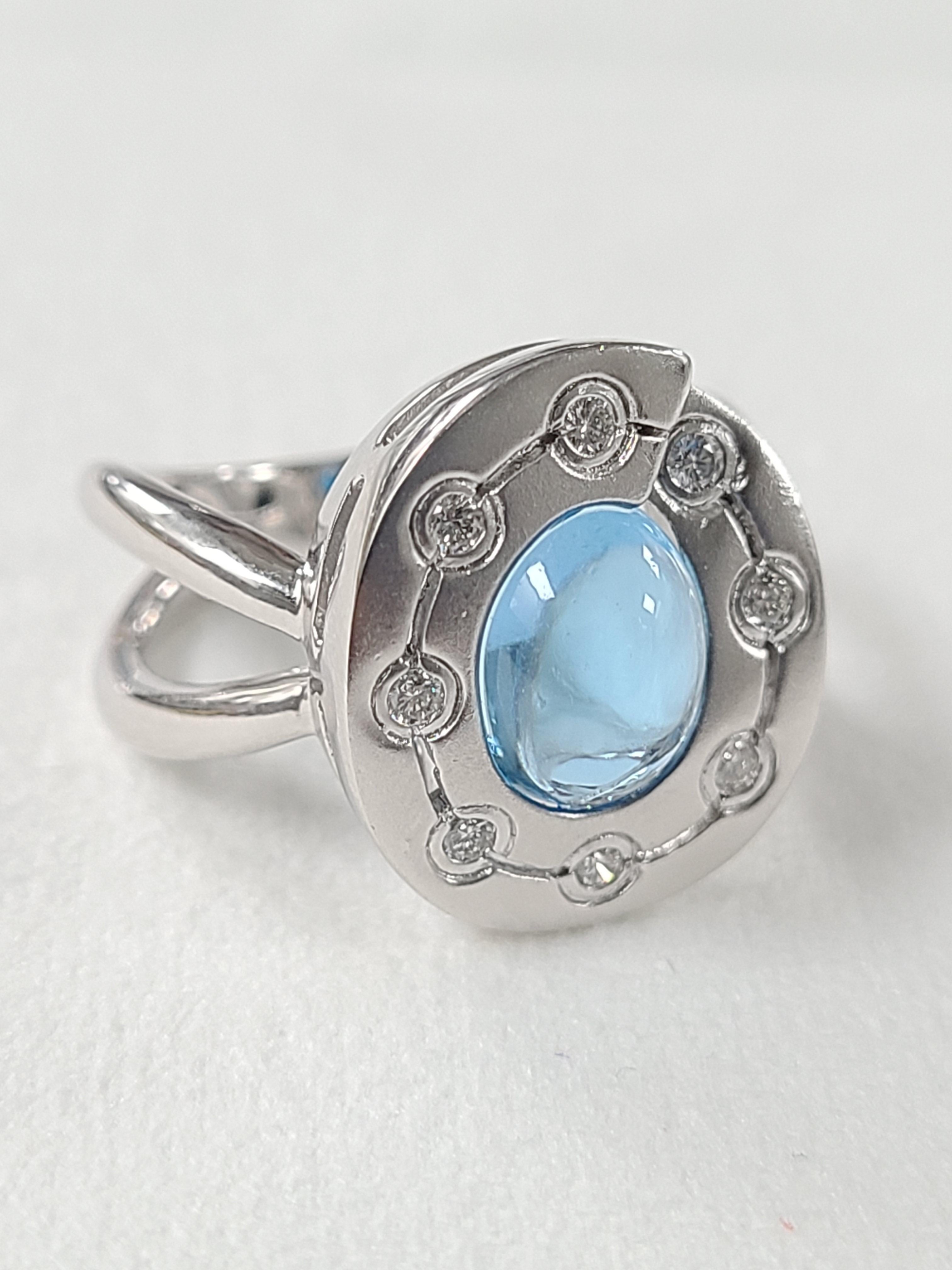 A gorgeous and chic Blue topaz ring set in 18k white gold with natural diamonds . The Ring is set in matt finish gold and high quality making. The topaz weight is 3.38 carats and diamond weight is .13 carats . Ring dimensions in cm 1.5 x 1.1 x 2.4