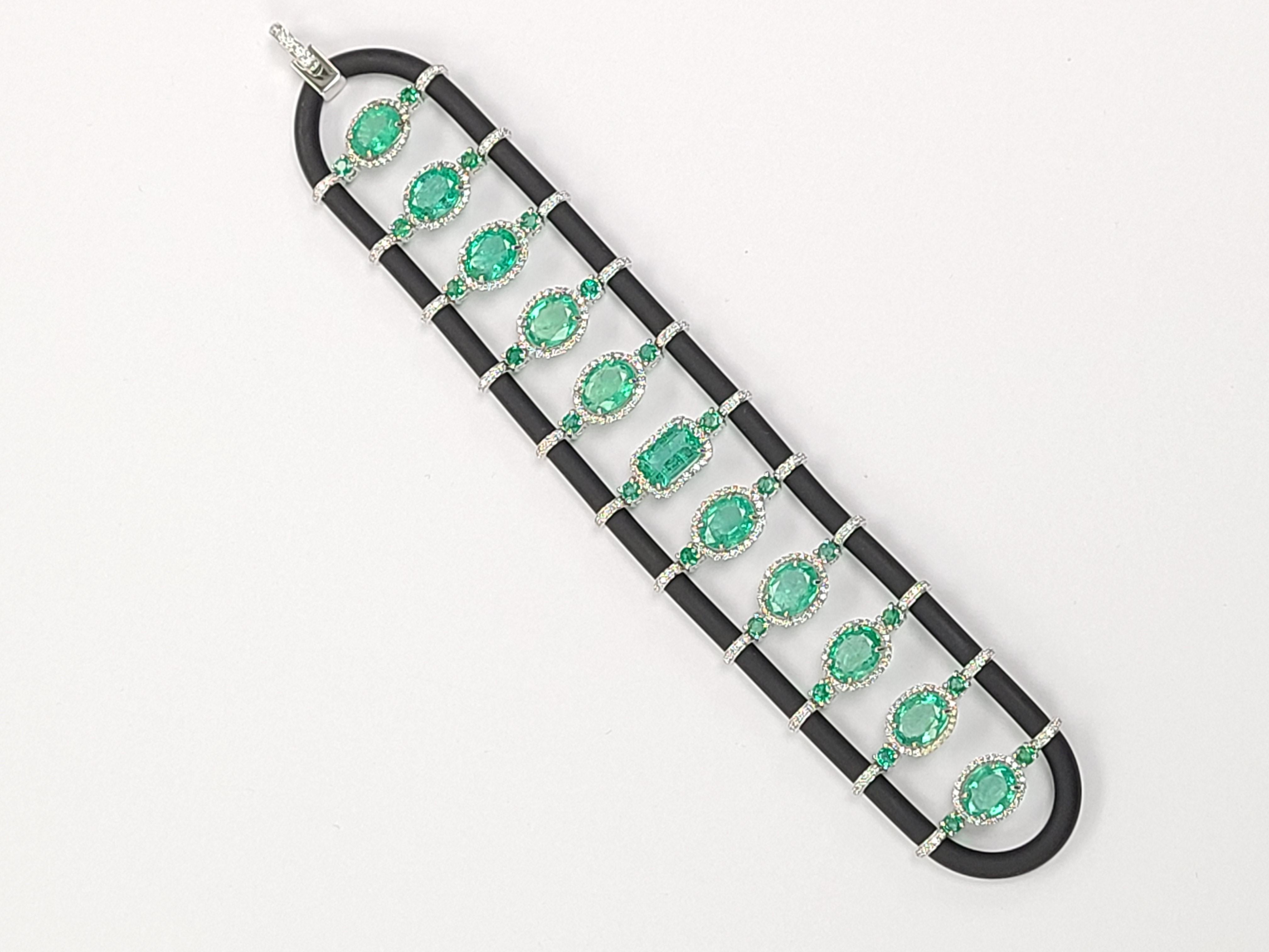 A beautiful and unique bracelet with black chord , emerald and diamonds . emeralds are natural with a weight of 20.39 carats and diamond weight is 2.21 carats . bracelet dimensions in cm 17.5 x 3.5 x .5 ( L X W X D ).
