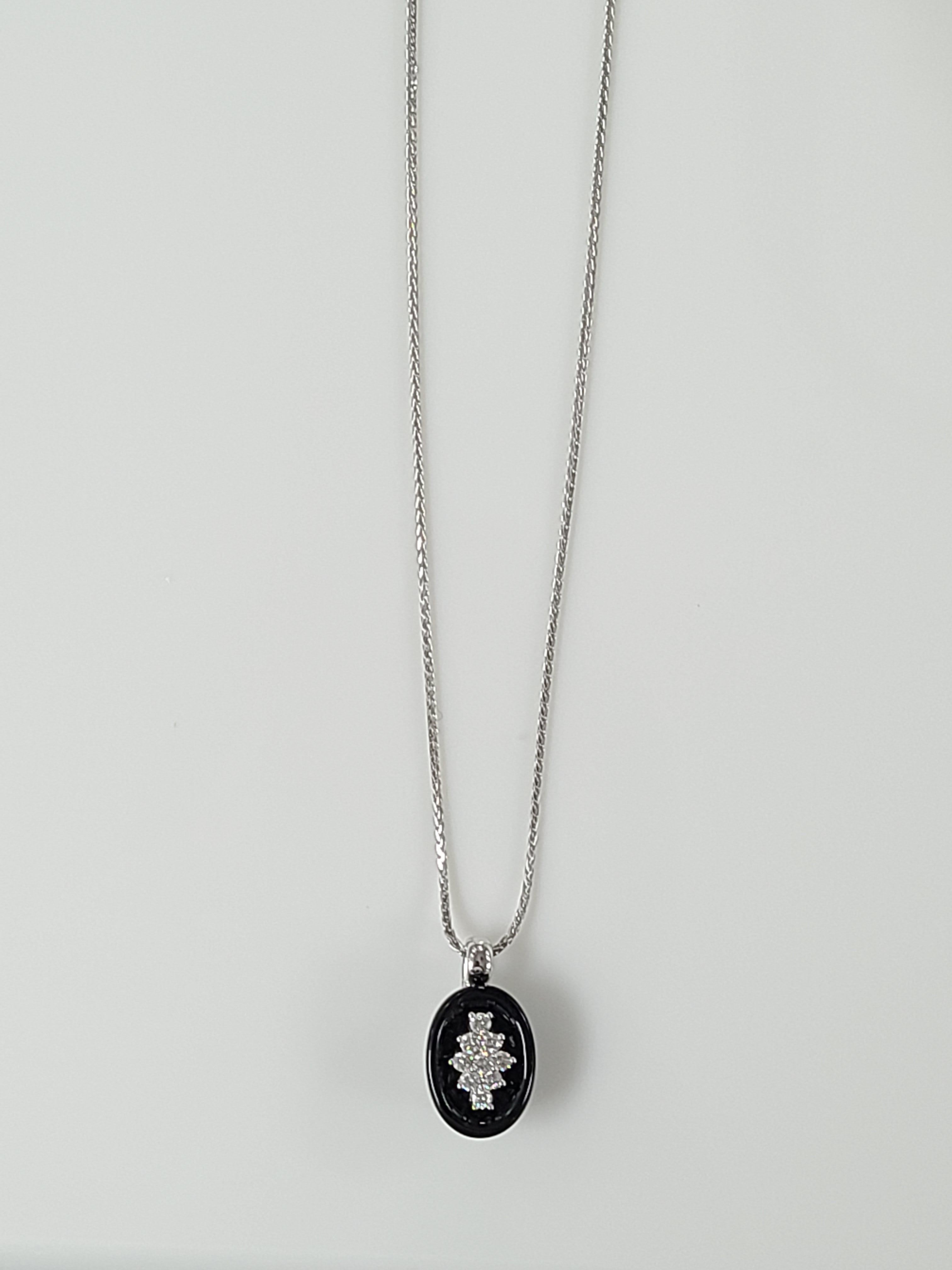 A beautifully designed pendant set in 18k white gold with onyx and diamonds . The length of chain with pendant approx in cm is 22.5 . The chain also has a efficient and simple mechanism to make the length of chain longer and shorter at ease. The