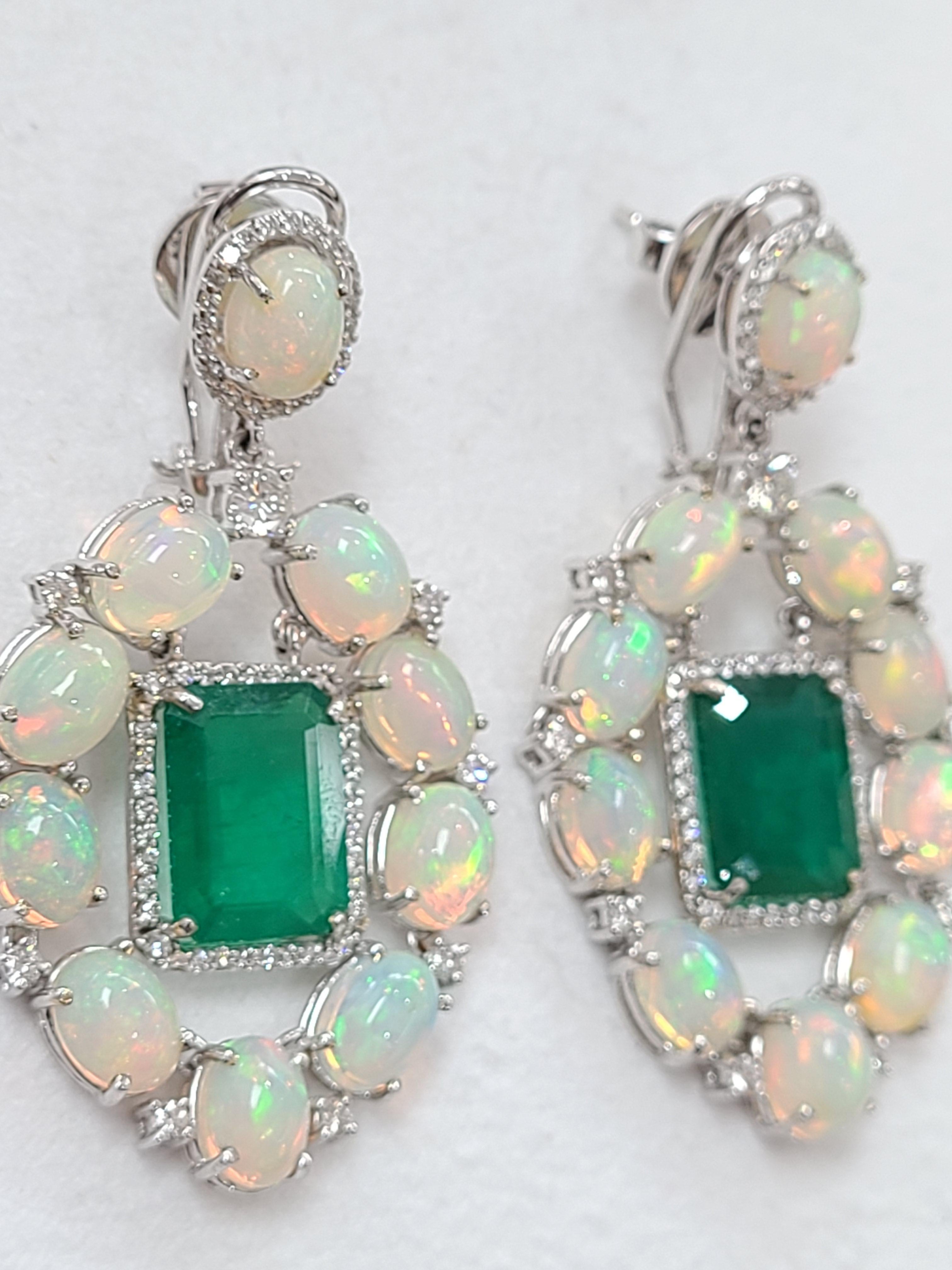 Modern and chic natural emerald and opal earrings set in 18k white gold . perfect for partywear and a for sure show stopper ! if you are looking for something unique , THIS IS IT ! emerald is natural from Zambia, weight is 11.02 carats and opal is