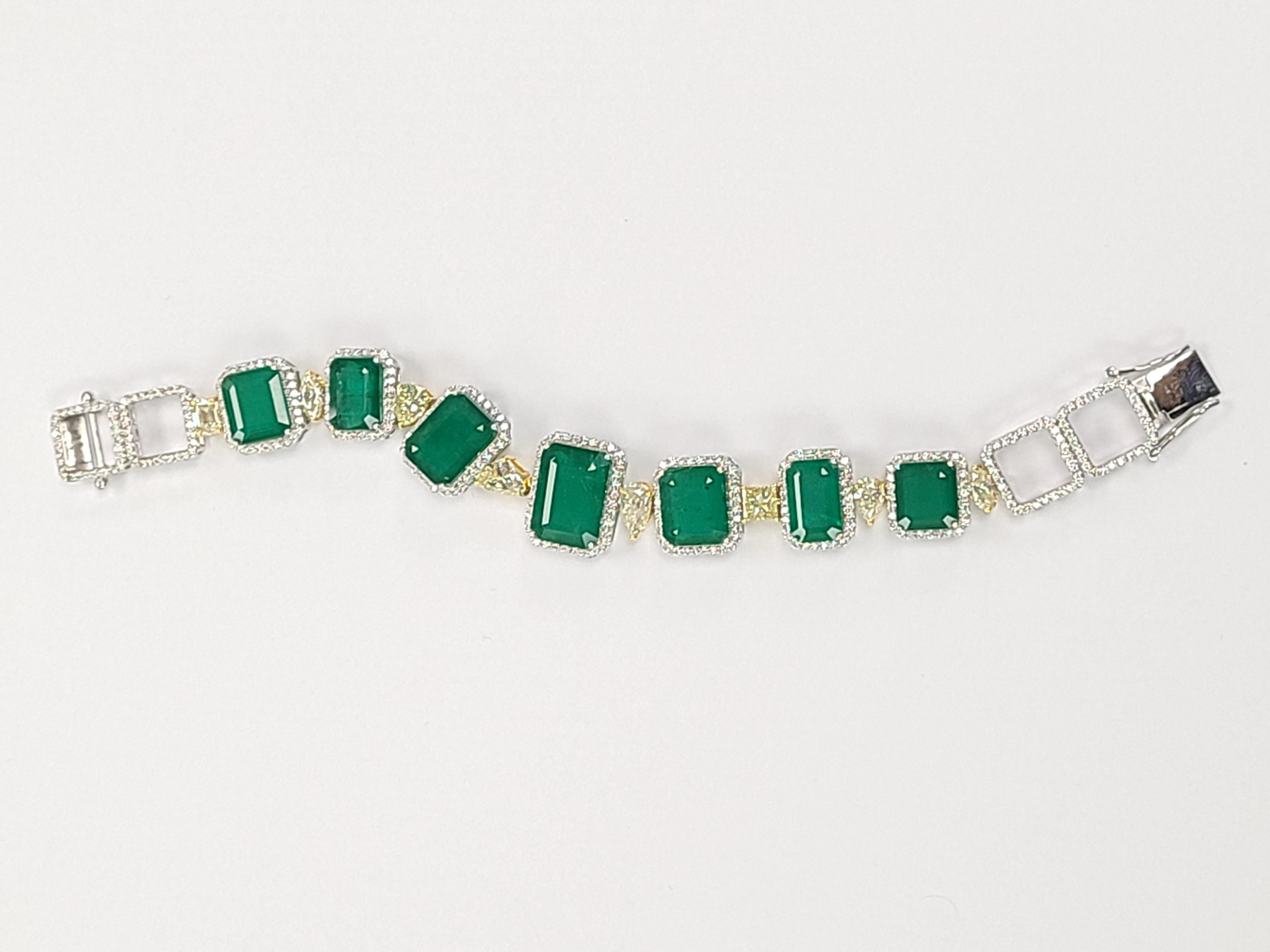 A gorgeous and elegant emerald bracelet with natural diamond in 18k gold . The emeralds are natural and weight is 39.29 carats , the diamond is also natural and combined weight is 8.08 carats . the bracelet dimensions in cm 17 x 2 x .8 ( L X W X D )