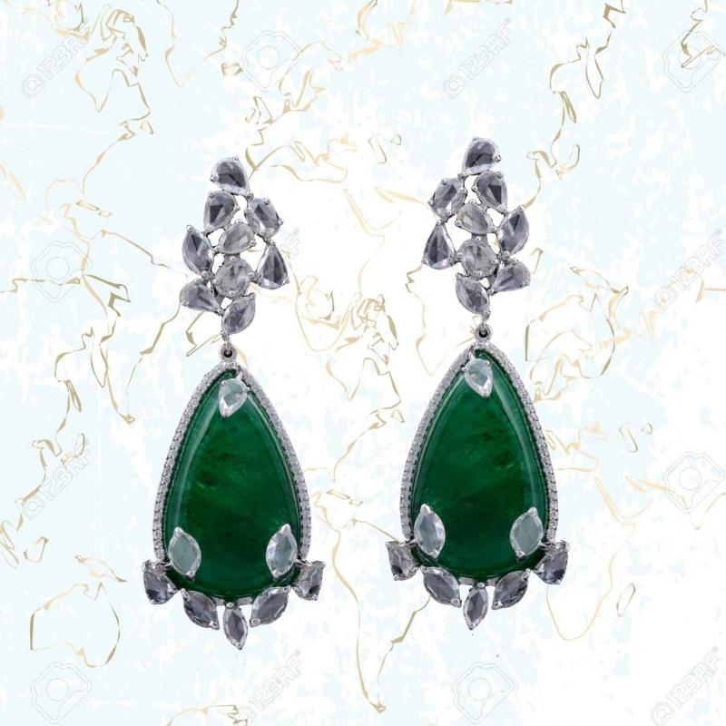 Classic Russian old-mine emerald earrings set in 18 Karat white gold and rose cut diamonds. The pair of emeralds together weigh 71.61 cts and rose cut diamonds weigh 7.61 cts. The earrings have a clip back with a simple pull-push mechanism.