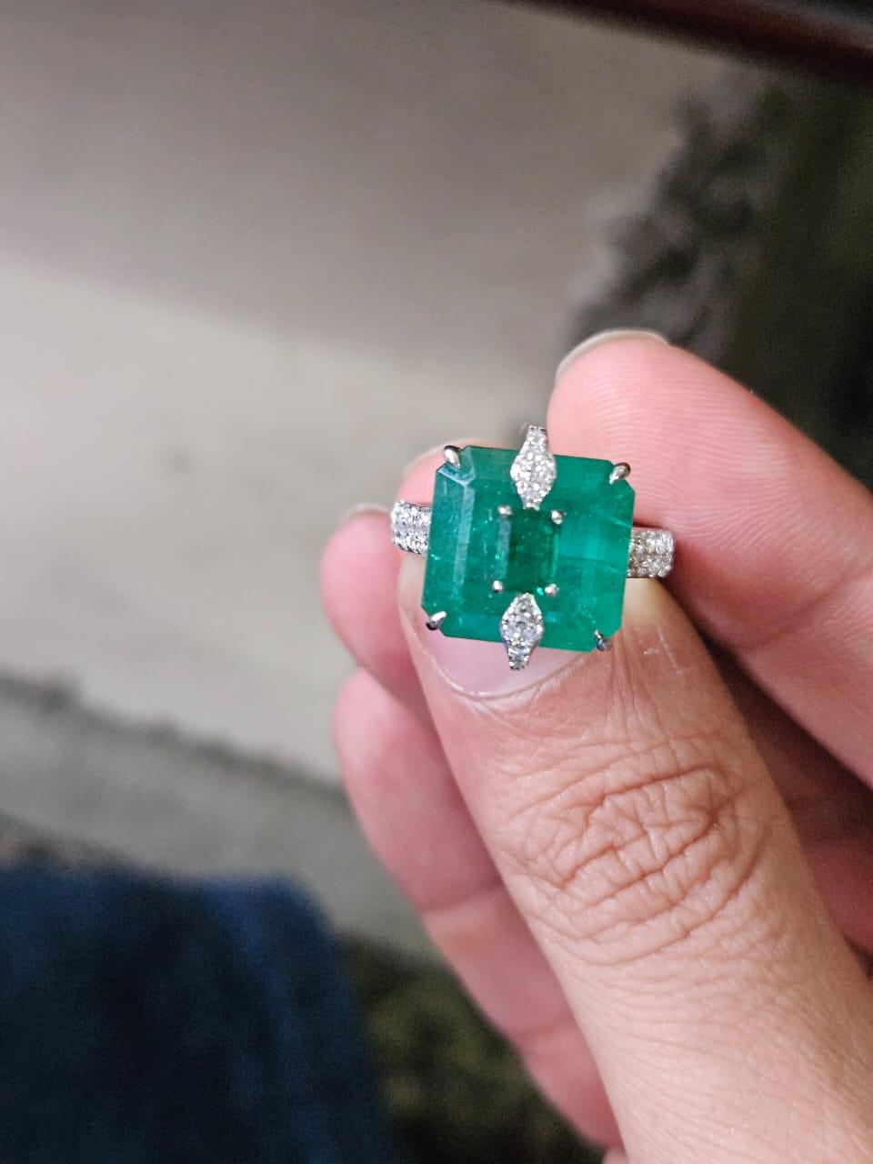 A very gorgeous and beautiful, modern style, Emerald Cocktail Engagement Ring set in 18K White Gold & natural Diamonds. The combined weight of the Emeralds is 11.56 carats. The Emeralds are completely natural, without any treatment and are of