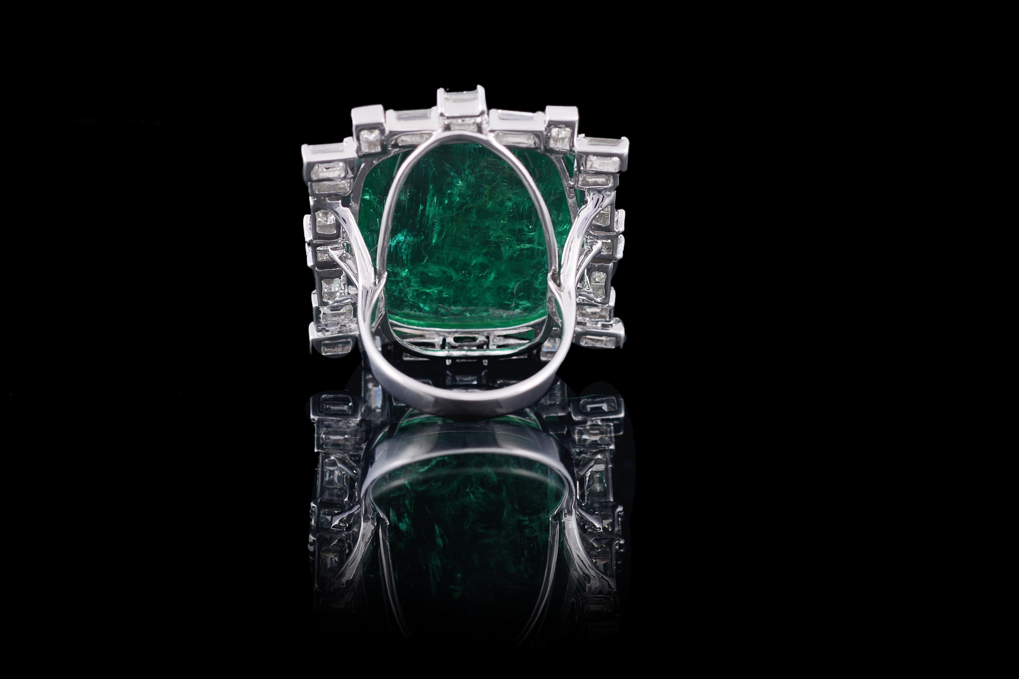 A classic Emerald & Diamond cocktail ring set in 18K Gold and Baguette Diamonds. The weight of the Emerald is 30.88 carats and is a completely natural from Zambia. The emerald is without any treatment. The weight of the diamonds is 3.85 carats. The