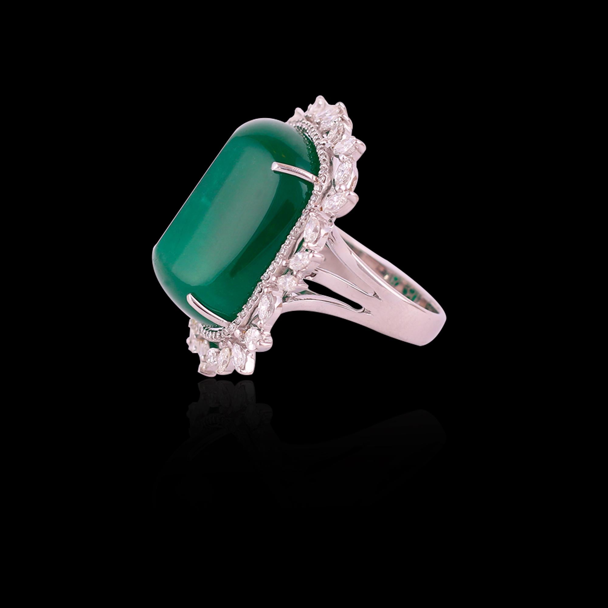 An exclusive Zambian Cabochon Emerald and Marquise Diamonds Cocktail Ring set in 18K Gold. The weight of the Zambian Emerald is 48.04 carats. The emerald is completely natural, without any treatment and originates from Zambia. The weight of the