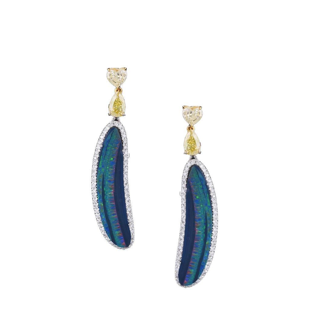 A very chic pair of Australian Doublet Earrings set in 18K gold and fancy shaped Yellow Diamonds. The weight of the opal is 13.65 carats. The opals are natural, Australian doublet. The weight of the diamonds 3.29 carats. The earrings have a simple