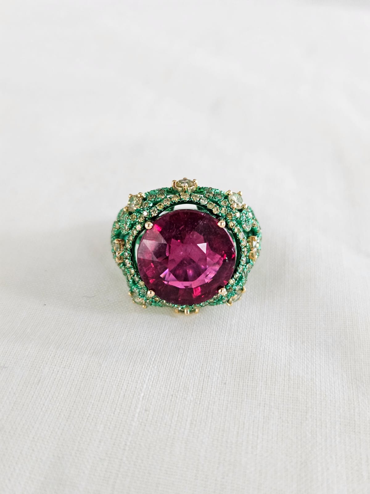 A very unique and one of a kind, Tourmaline Engagement Ring set in 18K Yellow Gold with Green Rhodium & Diamonds. The weight of the Tourmaline is 10.21 carats. The combined Diamonds weight is 1.83 carats. Net 18K Gold weight is 7.46 grams. The
