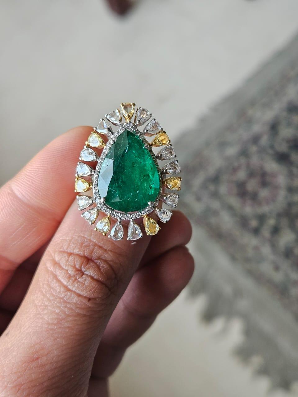 A very gorgeous and beautiful, statement style, Emerald Cocktail Engagement Ring set in 18K White Gold & natural Diamonds. The weight of the pear shaped Emerald is 10.40 carats. The Emerald is completely natural, without any treatment and is of