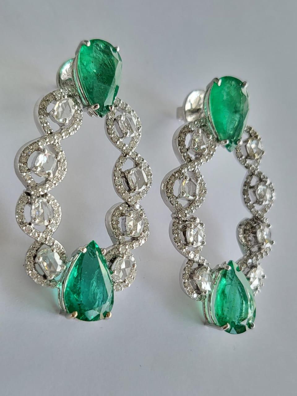 A very gorgeous and modern, Emerald Earrings set in 18K White Gold & Diamonds. The weight of the pear shaped Emeralds are 10.62 carats. The Emeralds are completely natural, without any treatment and is of Zambian origin. The weight of the Rose cut