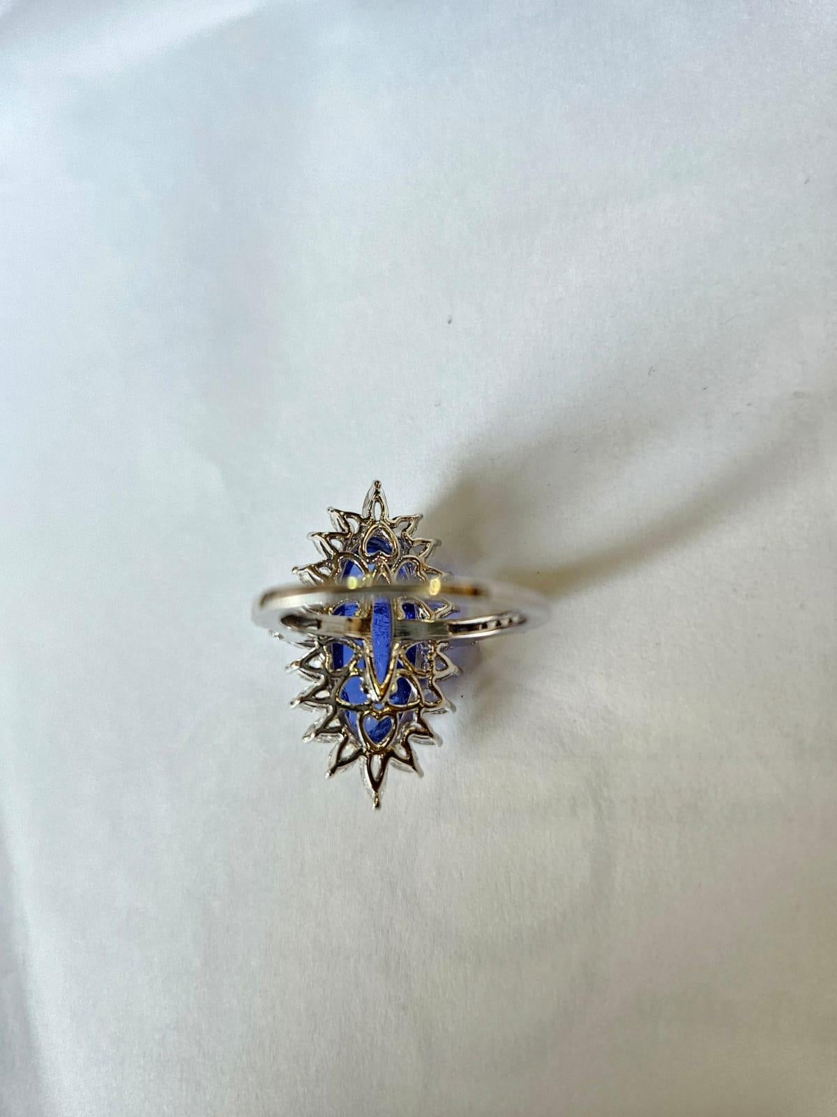 A very gorgeous and beautiful, Tanzanite Dome Cocktail Ring set in 18K White Gold & natural Diamonds. The weight of the Tanzanite Cabochon is 10.88 carats. The Tanzanite is responsibly sourced from Tanzania. The combined weight of the Diamonds is