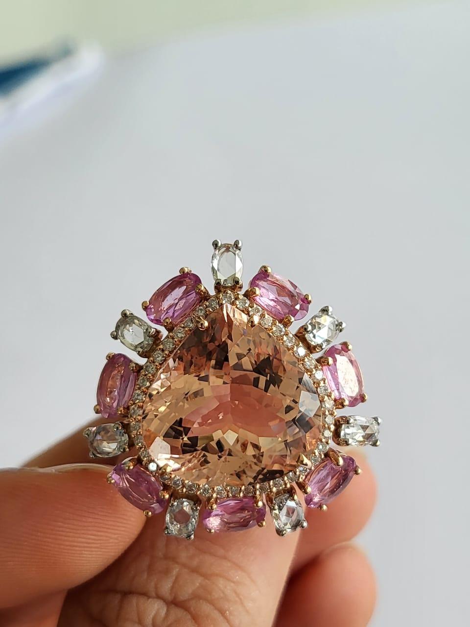 A very gorgeous and beautiful, Morganite & Pink Sapphires Cocktail Engagement Ring set in 18K Rose Gold & Diamonds. The weight of the Morganite is 11.13 carats. The weight of the Pink Sapphires is 2.31 carats. The Pink Sapphires are of Ceylon