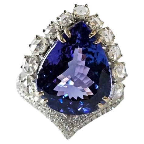 A very gorgeous and beautiful, modern style, Tanzanite Engagement Cocktail Ring set in 18K White Gold & natural Diamonds. The weight of the pear shaped Tanzanite 11.75 carats. The Tanzanite is responsibly sourced from Tanzania. The combined Diamonds