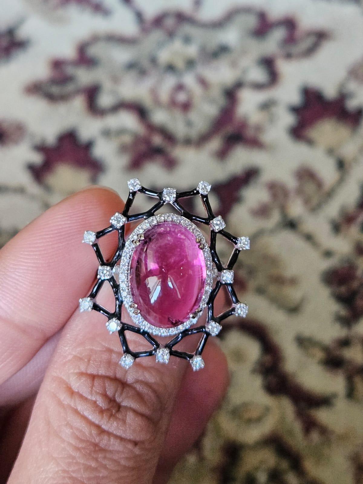 A very beautiful and gorgeous, Tourmaline & Black Enamel Cocktail Ring set in 18K White Gold & Diamonds. The weight of the Tourmaline cabochon is 12.18 carats. The Diamonds weight is 0.88 carats. Net 18K Gold weight is 5.26 grams. The gross weight
