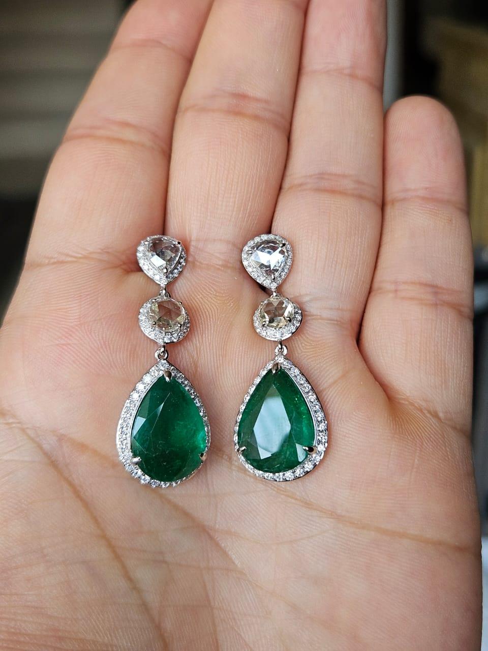 A very gorgeous and beautiful, modern style, Emerald Drop Earrings set in 18K White Gold & natural Diamonds. The weight of the pear shaped Emeralds 12.36 carats. The Emeralds are completely natural, without any treatment and are of Zambian origin.