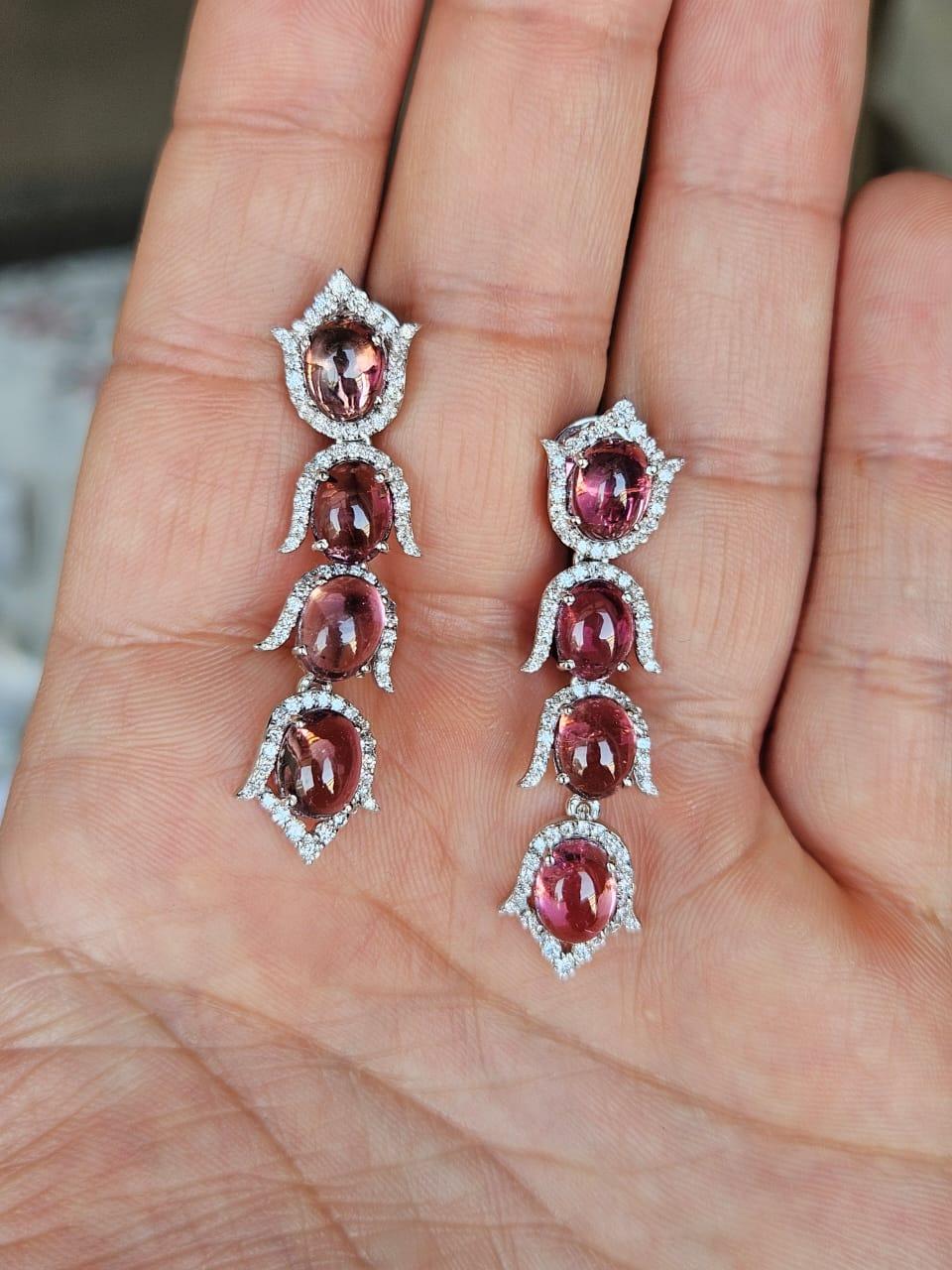 A very gorgeous and beautiful, Rubellite Chandelier Earrings set in 18K White Gold & natural Diamonds. The weight of the Rubellite Cabochons is 12.98 carats. The Diamonds weight is 1.32 carats. Net 18K Gold weight is 8.59 grams. The Gross weight of