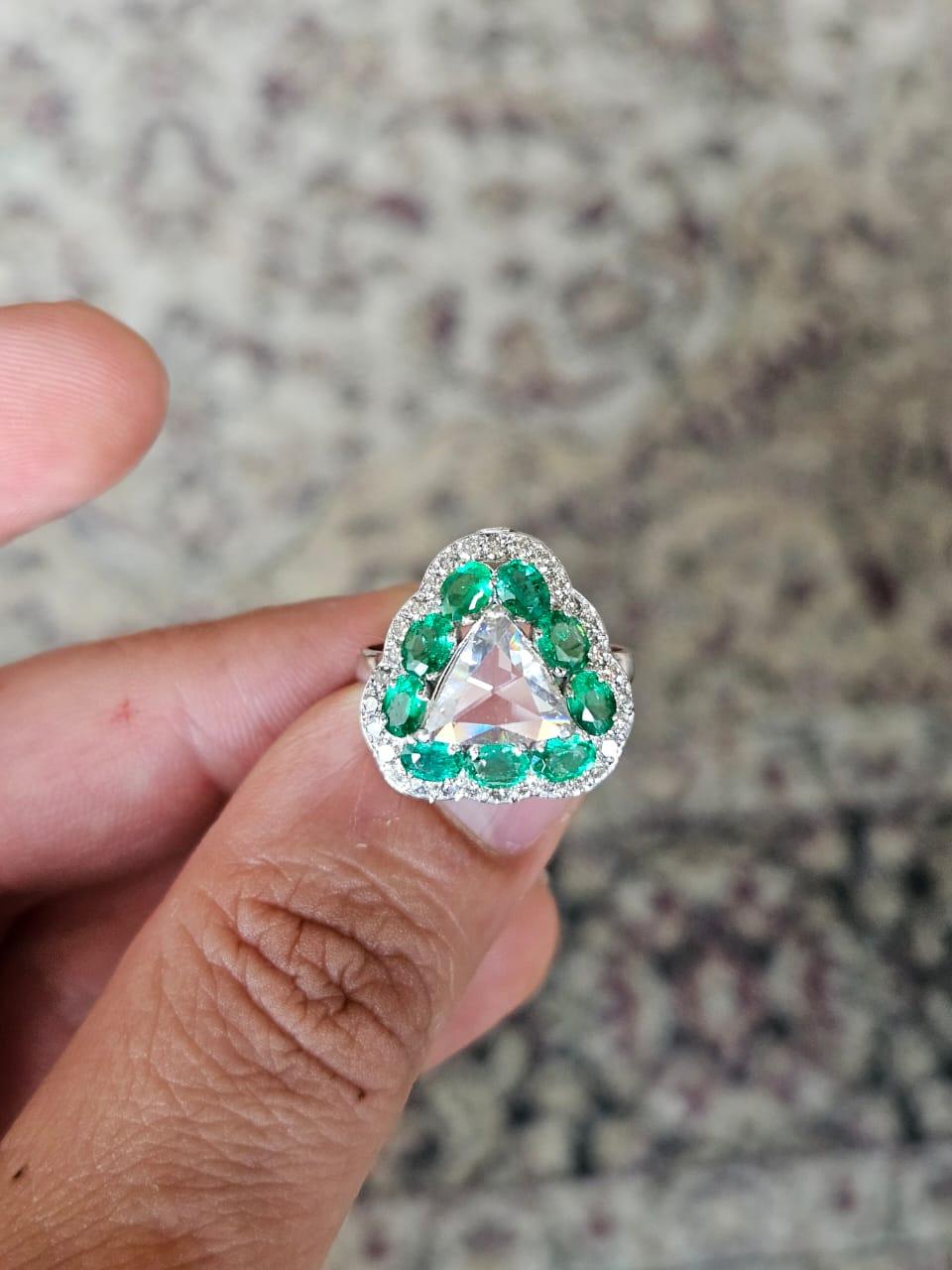 A very gorgeous and beautiful, art deco style, Emerald & Rose Cut Diamond Engagement Ring set in 18K White Gold. The weight of the Emeralds is 1.31 carats. The Emeralds are completely natural, without any treatment and are of Zambian origin. The