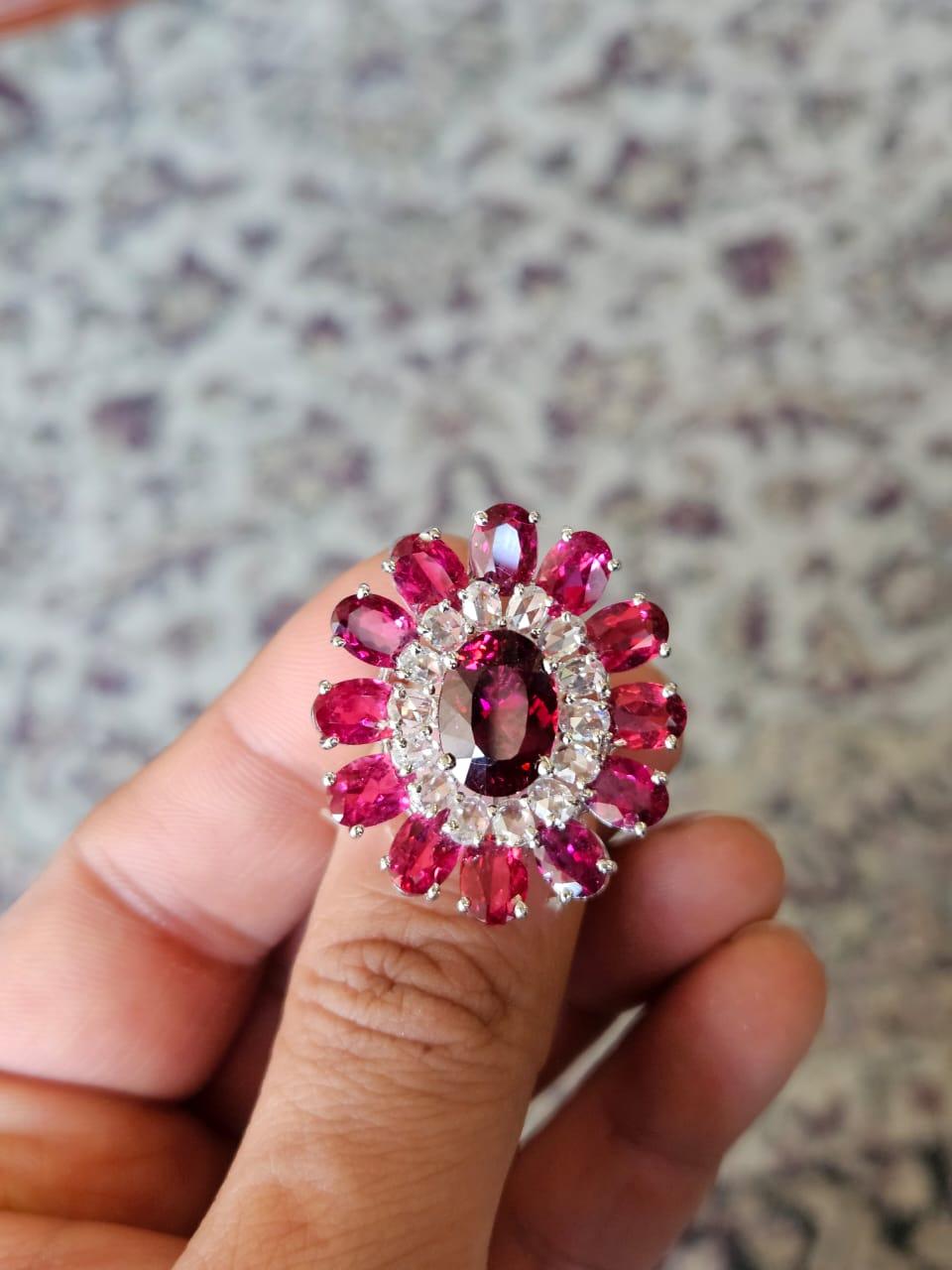 A very beautiful and modern, Rubellite Cocktail Ring set in 18K White Gold & Diamonds. The combined weight of the Rubellites is 14.42 carats. The Diamonds weight is 1.35 carats. Net 18K Gold weight is 7.59 grams. The gross weight of the ring is