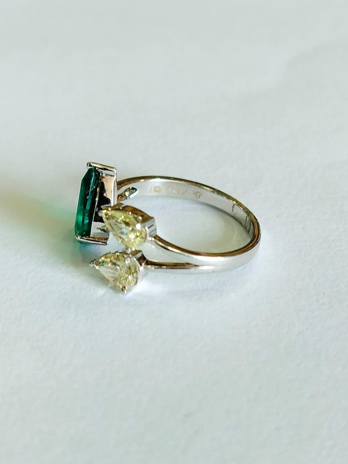 A very gorgeous and one of a kind, Emerald Engagement Ring set in 18K Gold & Diamonds. The weight of the Emerald is  1.46 carats. The Emerald is completely natural, without any treatment and is of Zambian origin. The Diamonds weight is 0.87 carats.