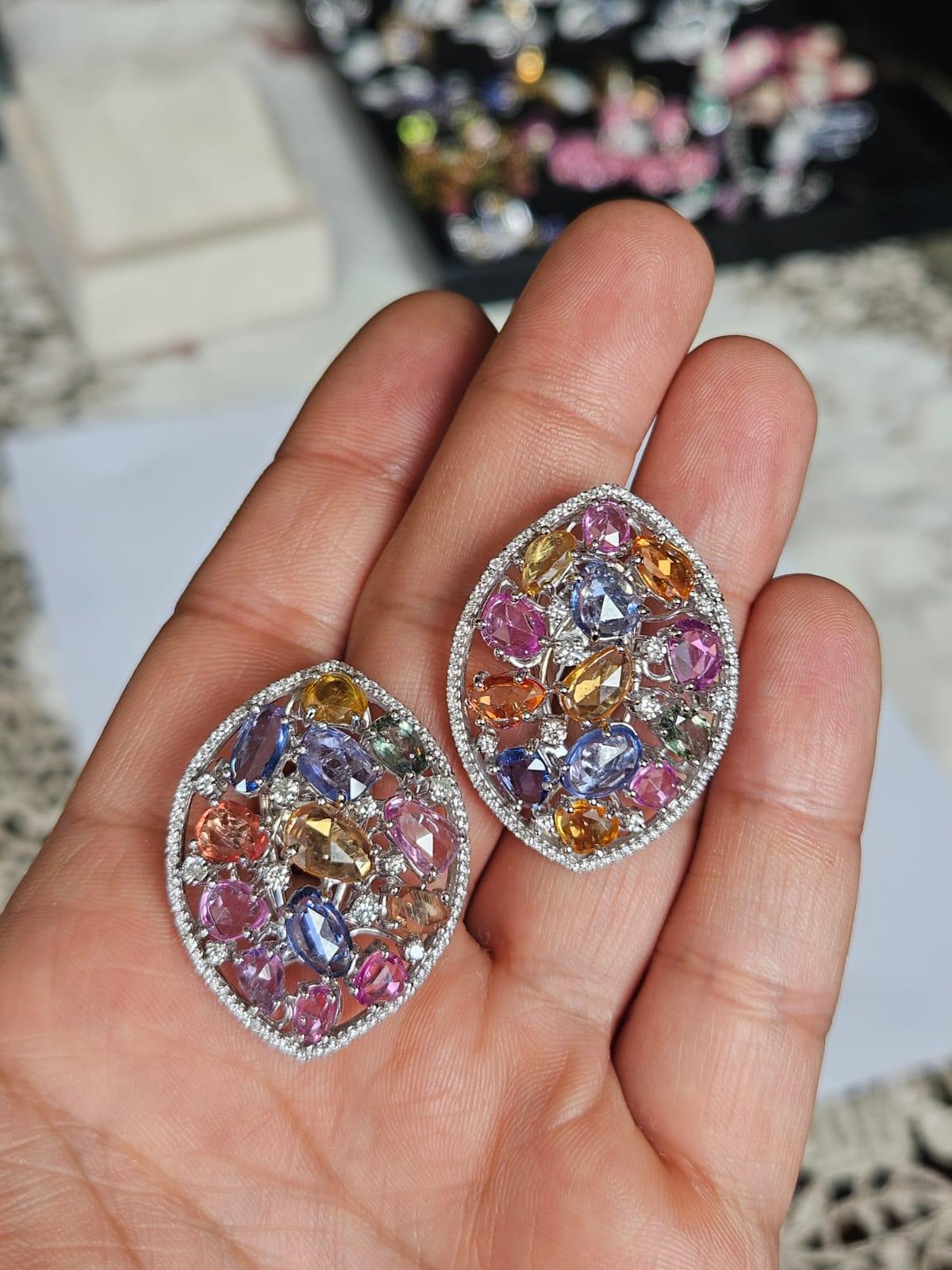 A very gorgeous and beautiful, Muti Sapphires Stud Earrings set in 18K White Gold & natural Diamonds. The weight of the Multi Sapphire Rose Cuts is 14.84 carats. The Multi Sapphires are of Ceylon (Sri Lankan) origin. The Diamonds weight is 1.24