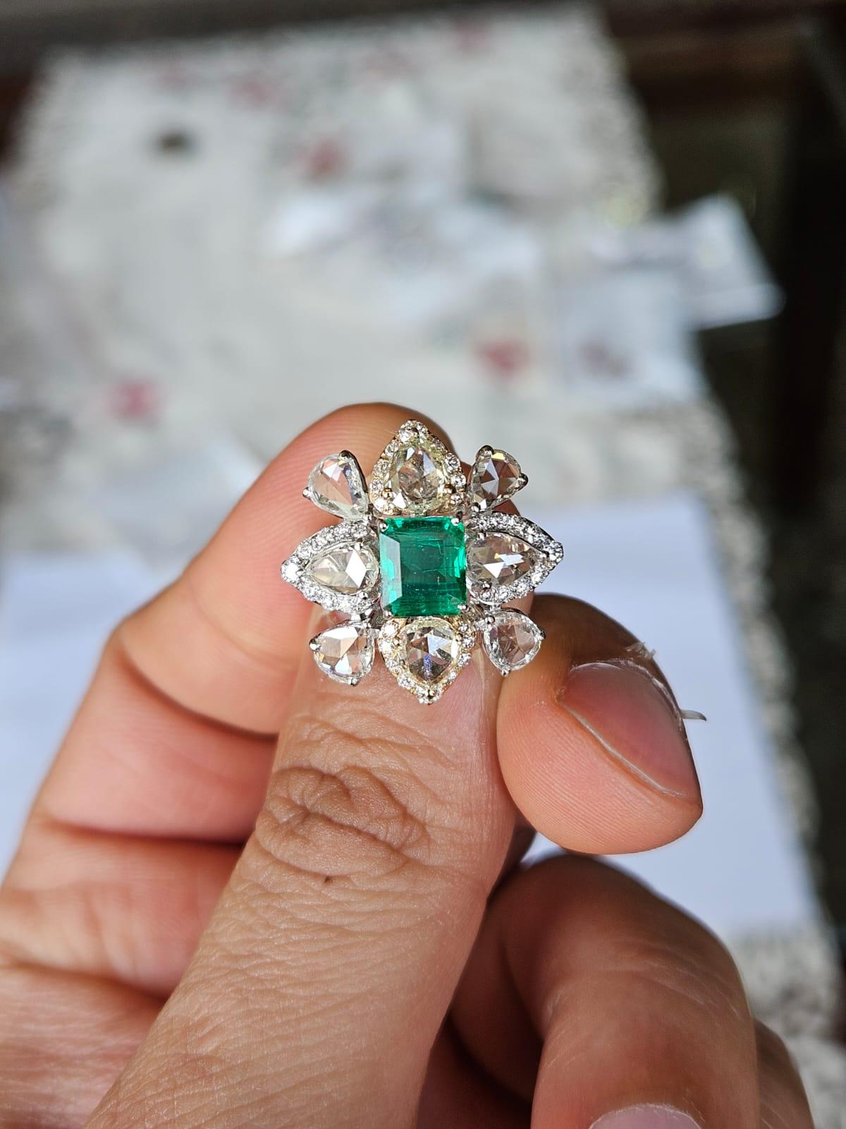 A very gorgeous and beautiful, modern style, Emerald Engagement Ring set in 18K White Gold & natural Diamonds. The weight of the Emerald is 1.52 carats. The Emerald is completely natural, without any treatment and is of Zambian origin. The combined