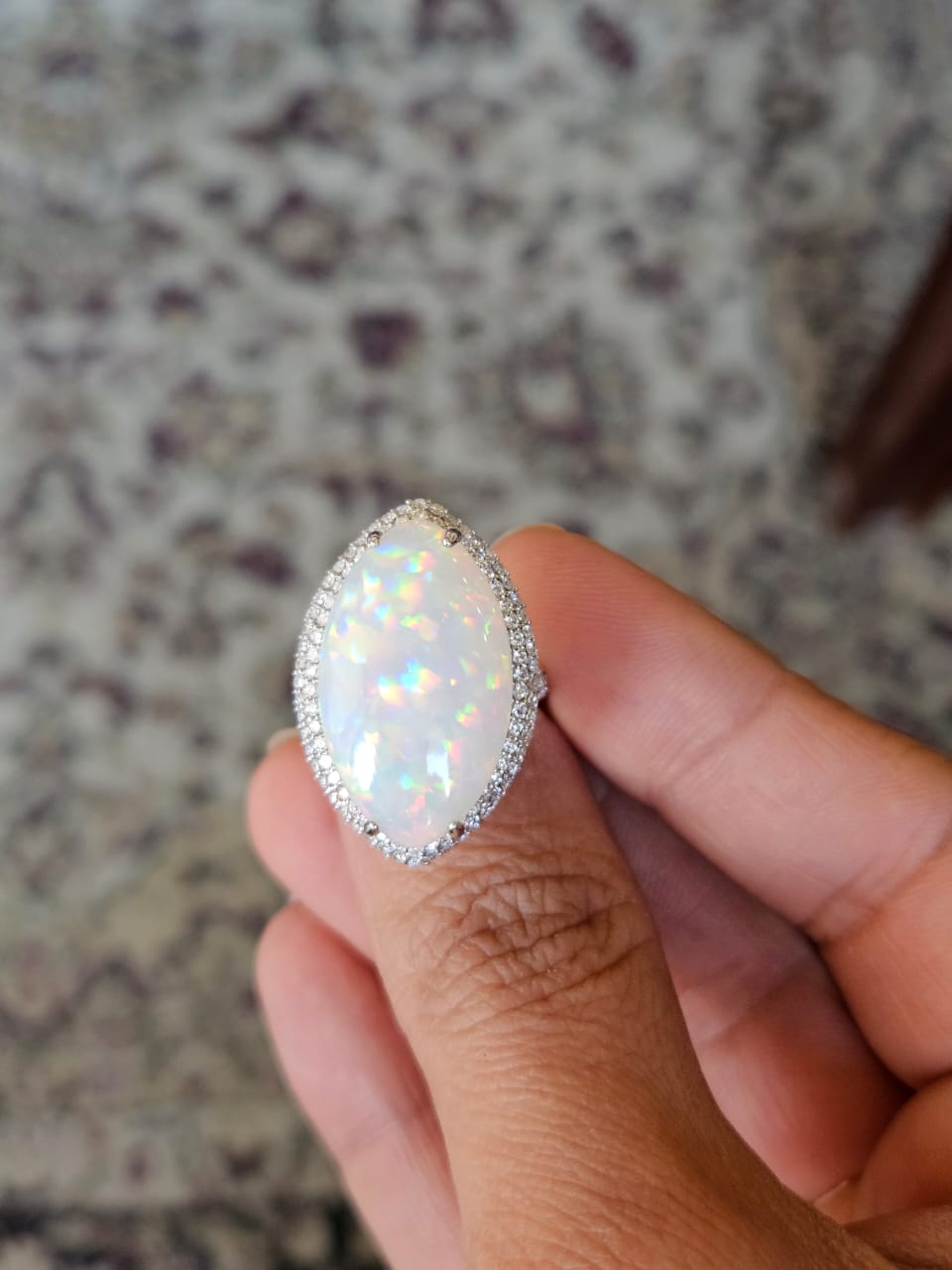 A very unique and beautiful, Opal Dome Cocktail Ring set in 18K White Gold & Diamonds. The weight of the Marquise shaped Opal Cabochon is 16.01 carats. The Opal is of Ethiopian origin. The Diamonds weight is 1.00 carats. Net 18K Gold weight is 6.32