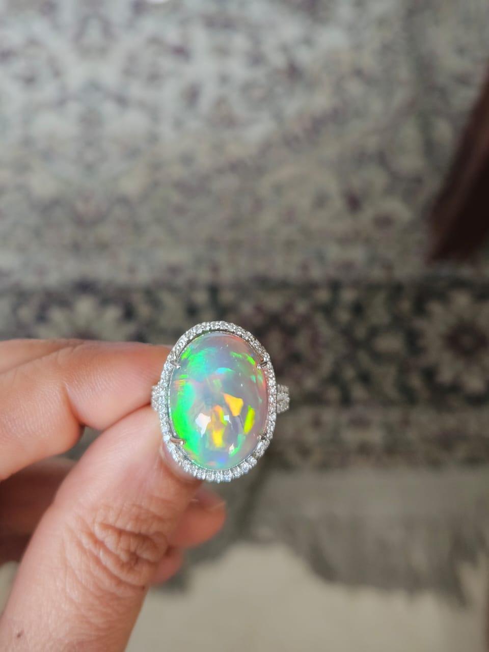 A very gorgeous and beautiful, Ethiopian Opal & Diamonds Cocktail Engagement Ring. The weight of the Ethiopian Opal is 16.23 carats. The Diamonds weight is 0.60 carats. Net 18K Gold weight is 5.32 grams. The Gross weight of the Ring is 8.69 grams.