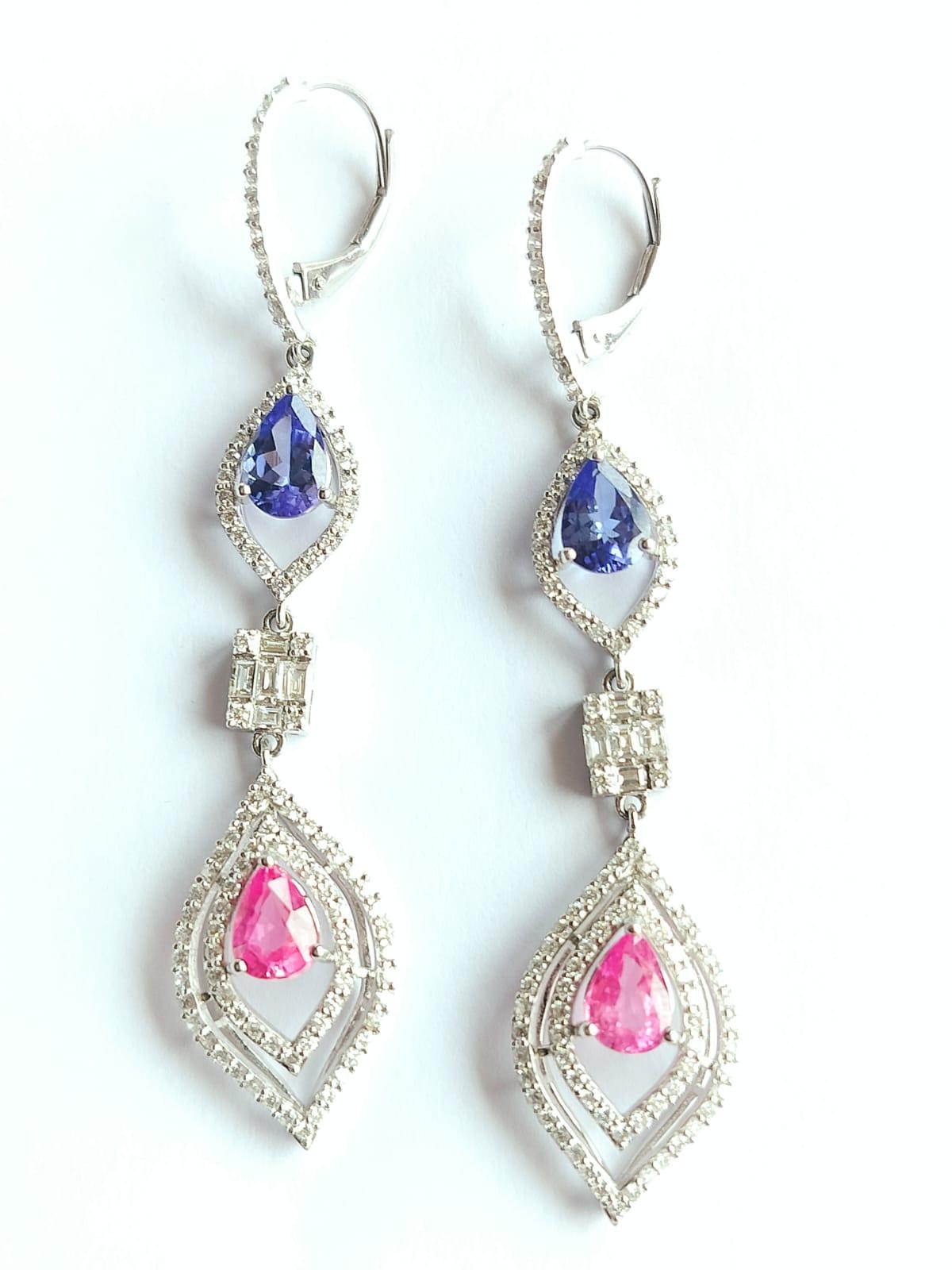 A very gorgeous and beautiful, Modern style Tanzanite Pink Sapphire Dangle Earrings set in 18K Gold. The weight of the Tanzanite is 1.69 carats. The Tanzanite is responsibly sourced from Tanzania. The weight of Pink Sapphire is 1.95 carats. The Pink