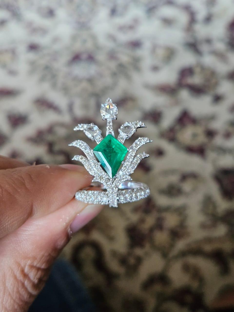 A stunning and gorgeous, Emerald Cocktail Ring set in 18K White Gold & Diamonds. The weight of the kite shaped Emerald is 1.70 carats. The Emerald is completely natural, without any treatment and is of Zambian origin. The weight of the Rose Cut